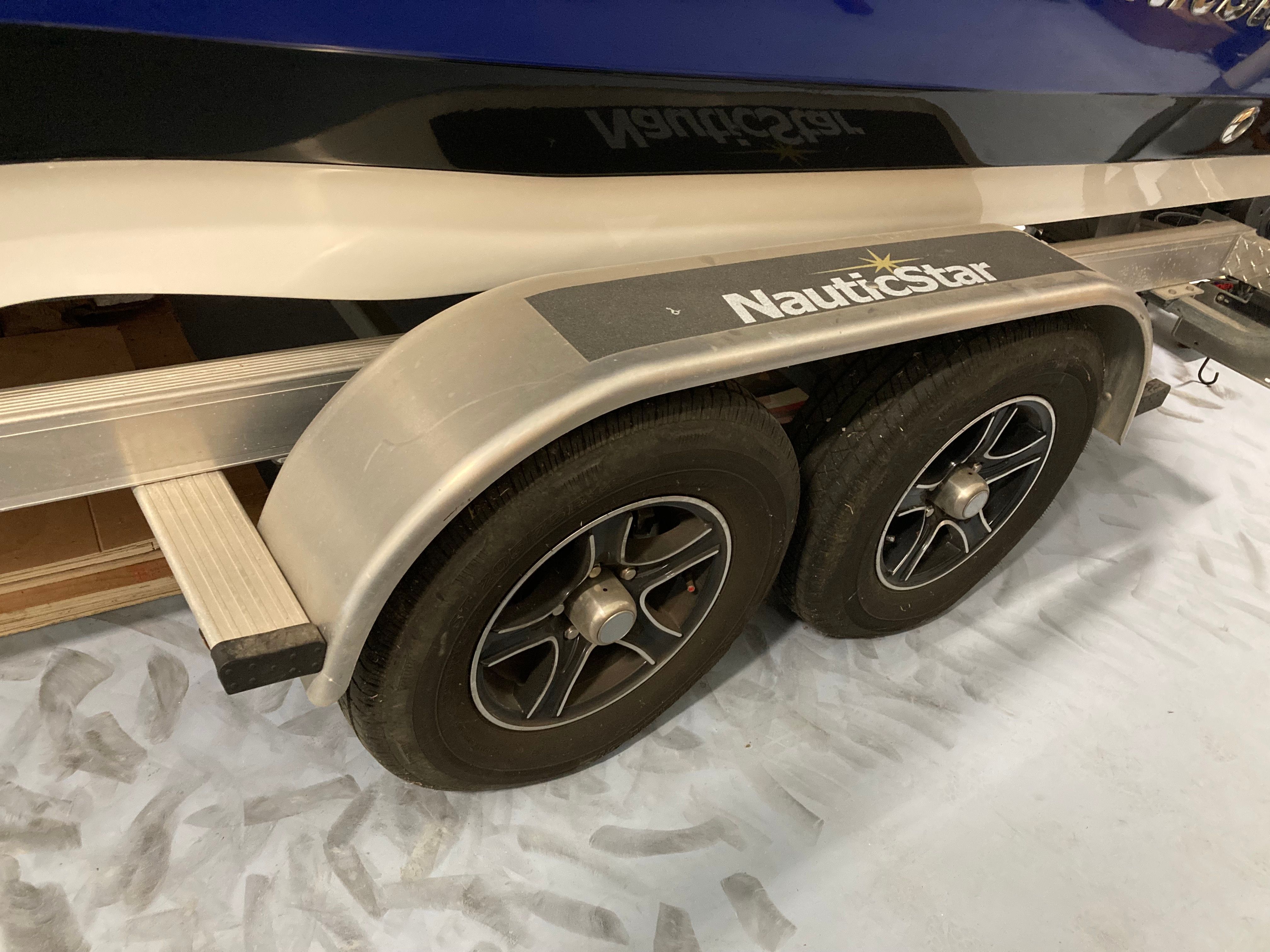 Close-up of a boat trailer with two wheels and NauticStar logo.