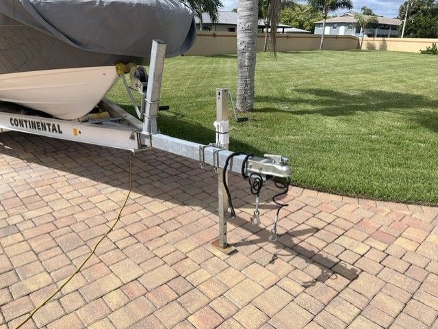 2015 Yamaha 242 Limited S on Continental trailer, covered, on paved driveway.