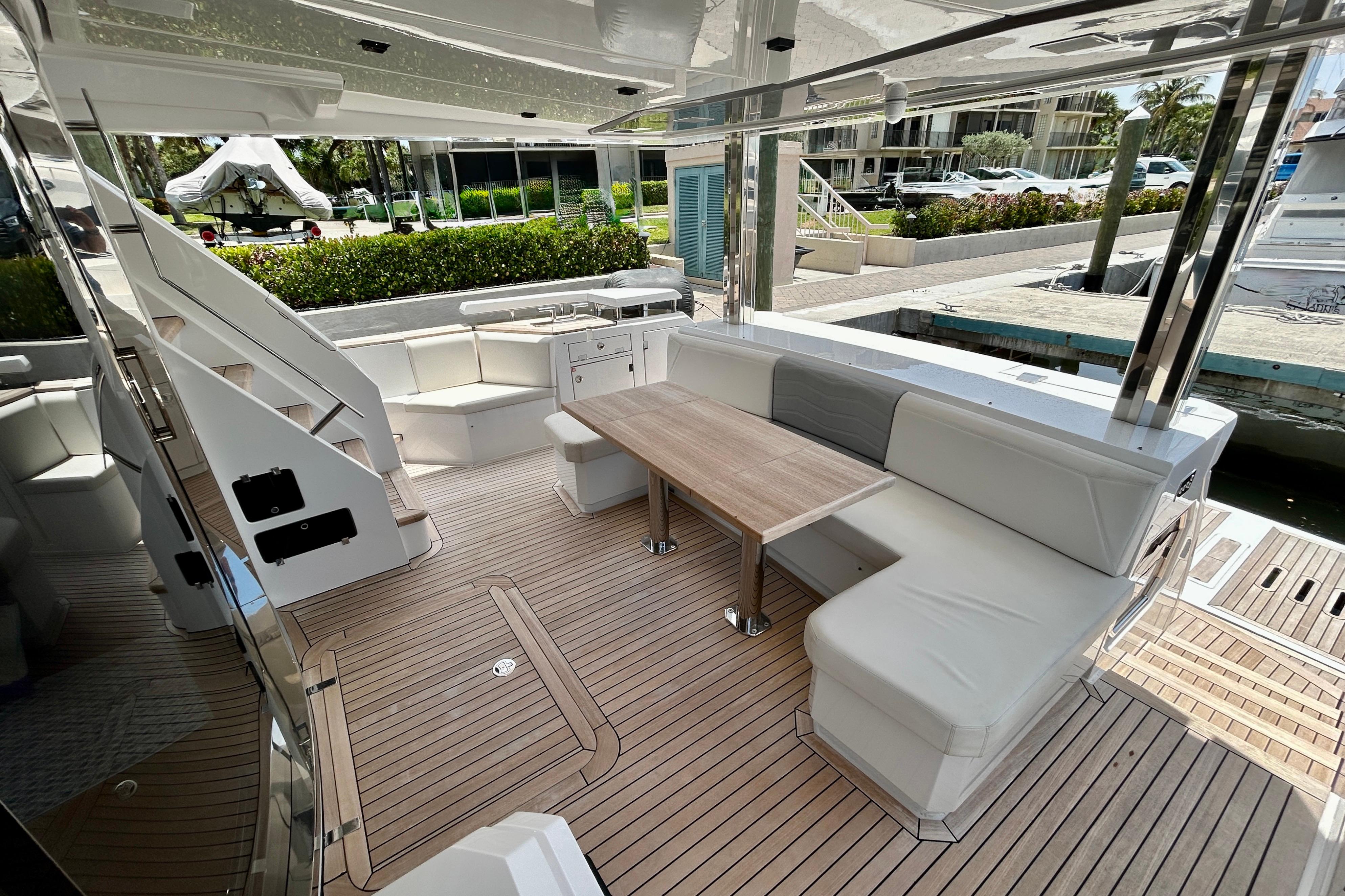 Luxurious 2024 Aicon Vivere 66 yacht interior with elegant seating and wooden flooring.
