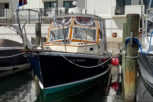 1978 Dyer 29 Trunk Cabin boat docked at a marina, front view.