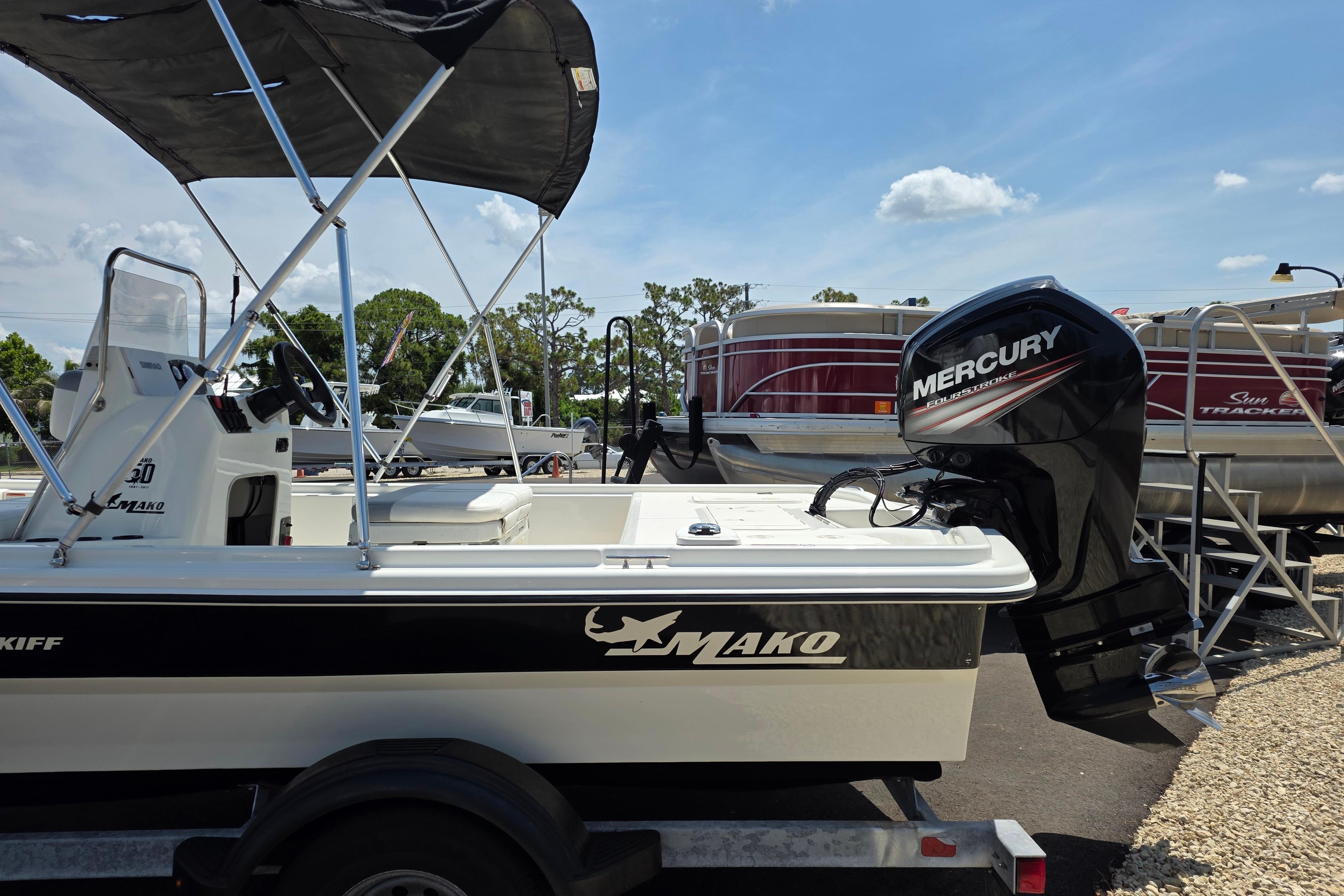 2018 Mako Pro Skiff 19 CC boat with Mercury engine, parked on a trailer.