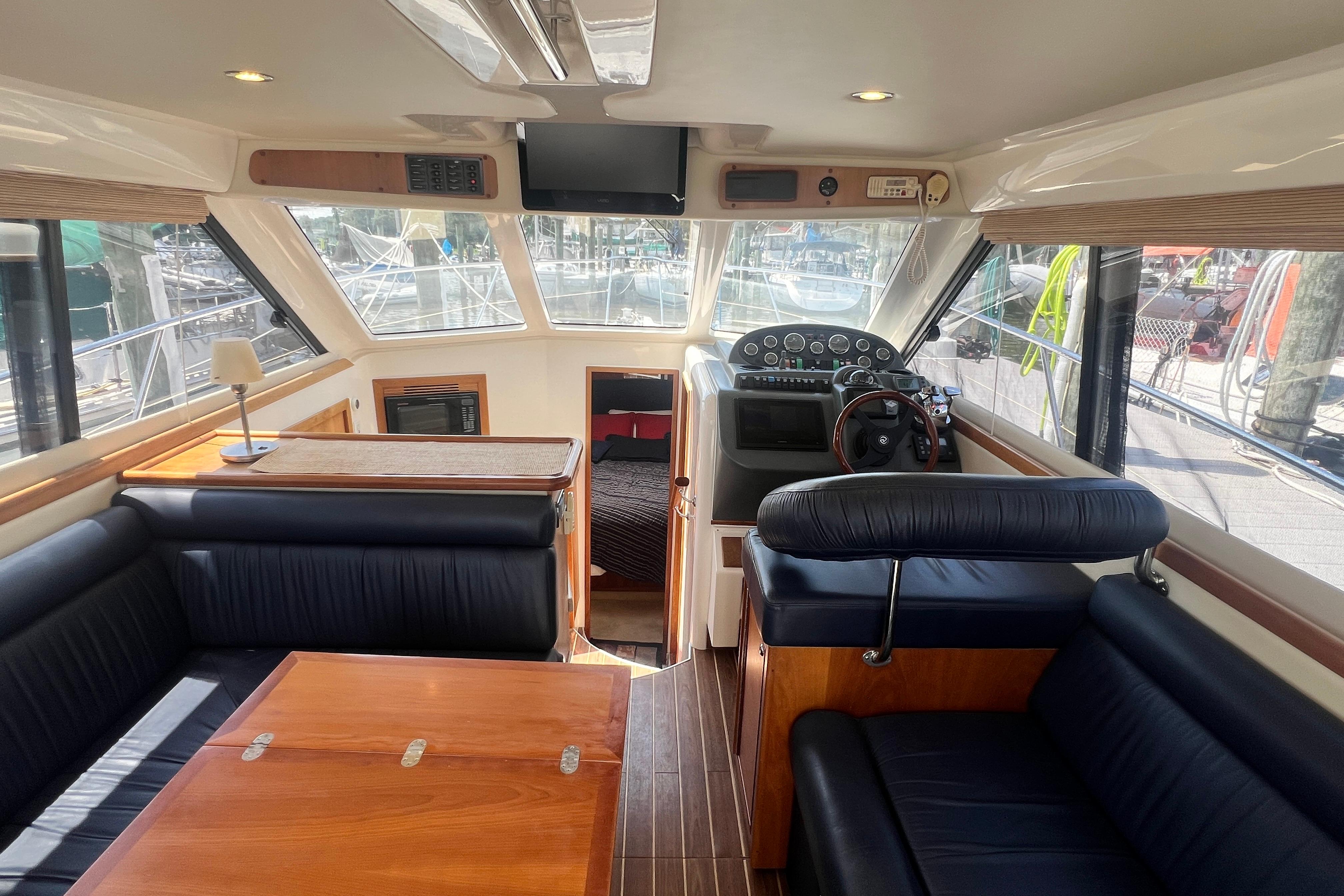 Interior of 2007 Riviera 33 Flybridge yacht with helm, seating, and dining area.