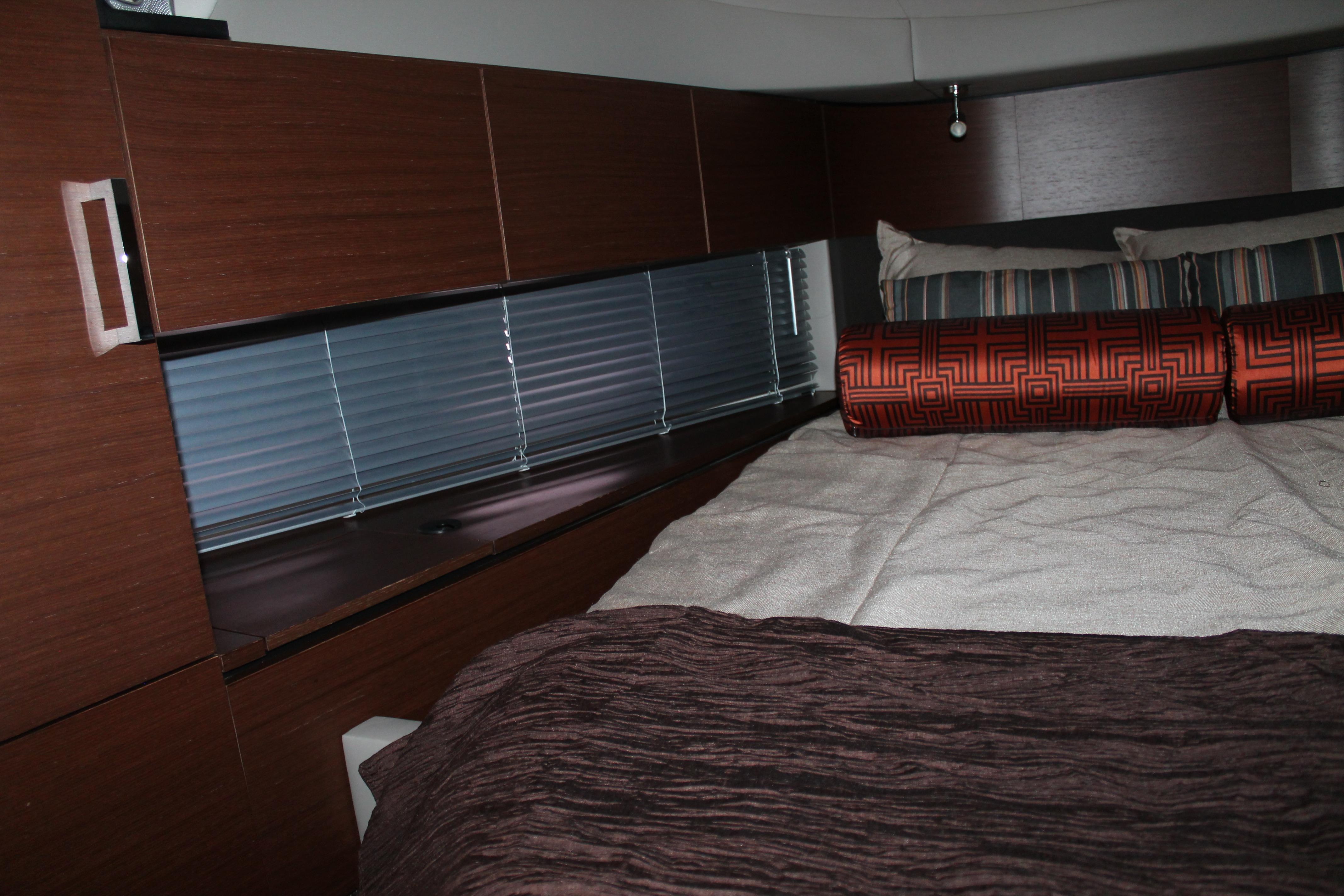 Luxurious cabin interior of 2015 Sea Ray 470 Sundancer yacht with elegant bedding.