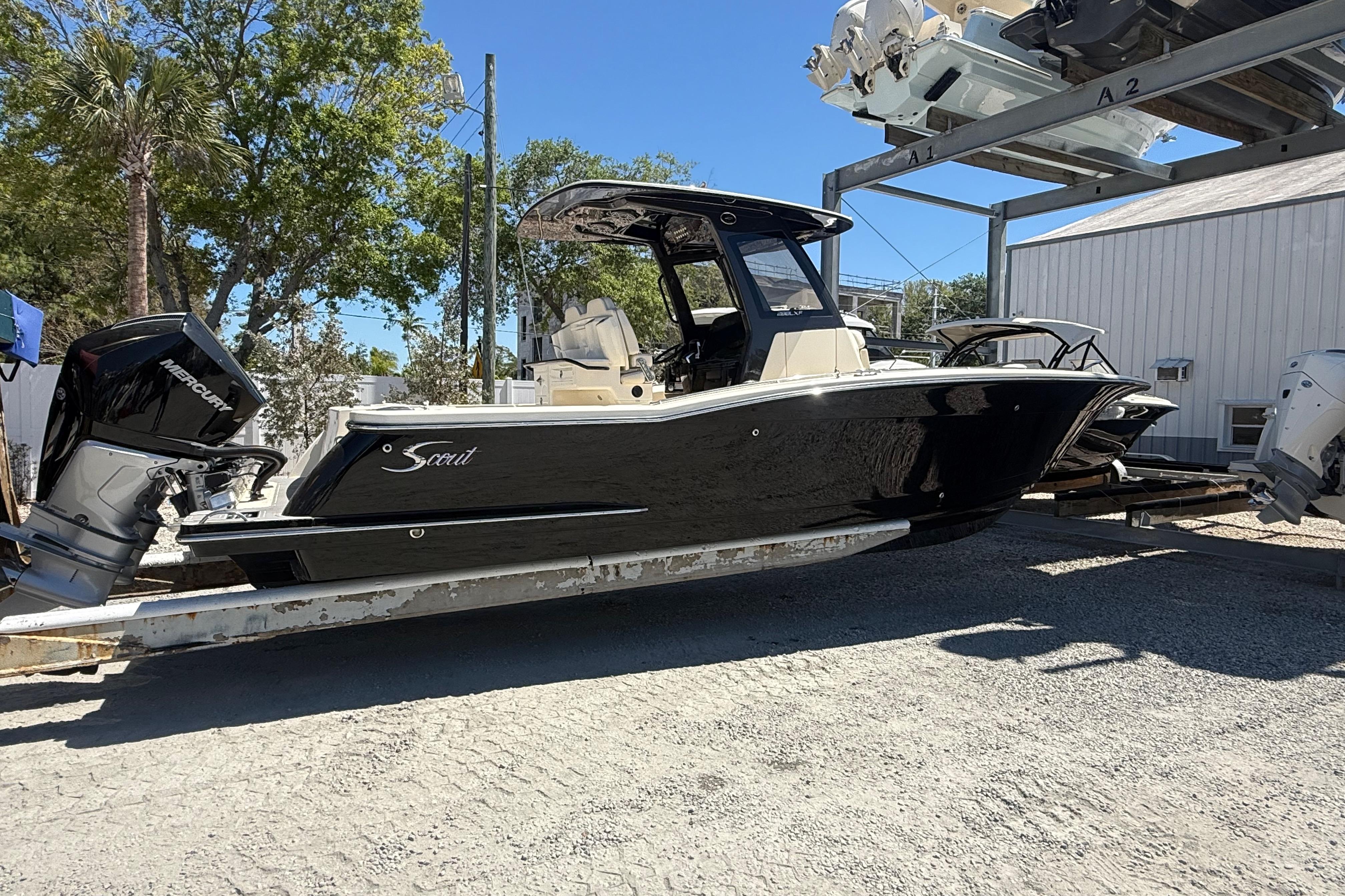 2026 Scout 288 LXF boat with Mercury engine on a trailer, outdoors.