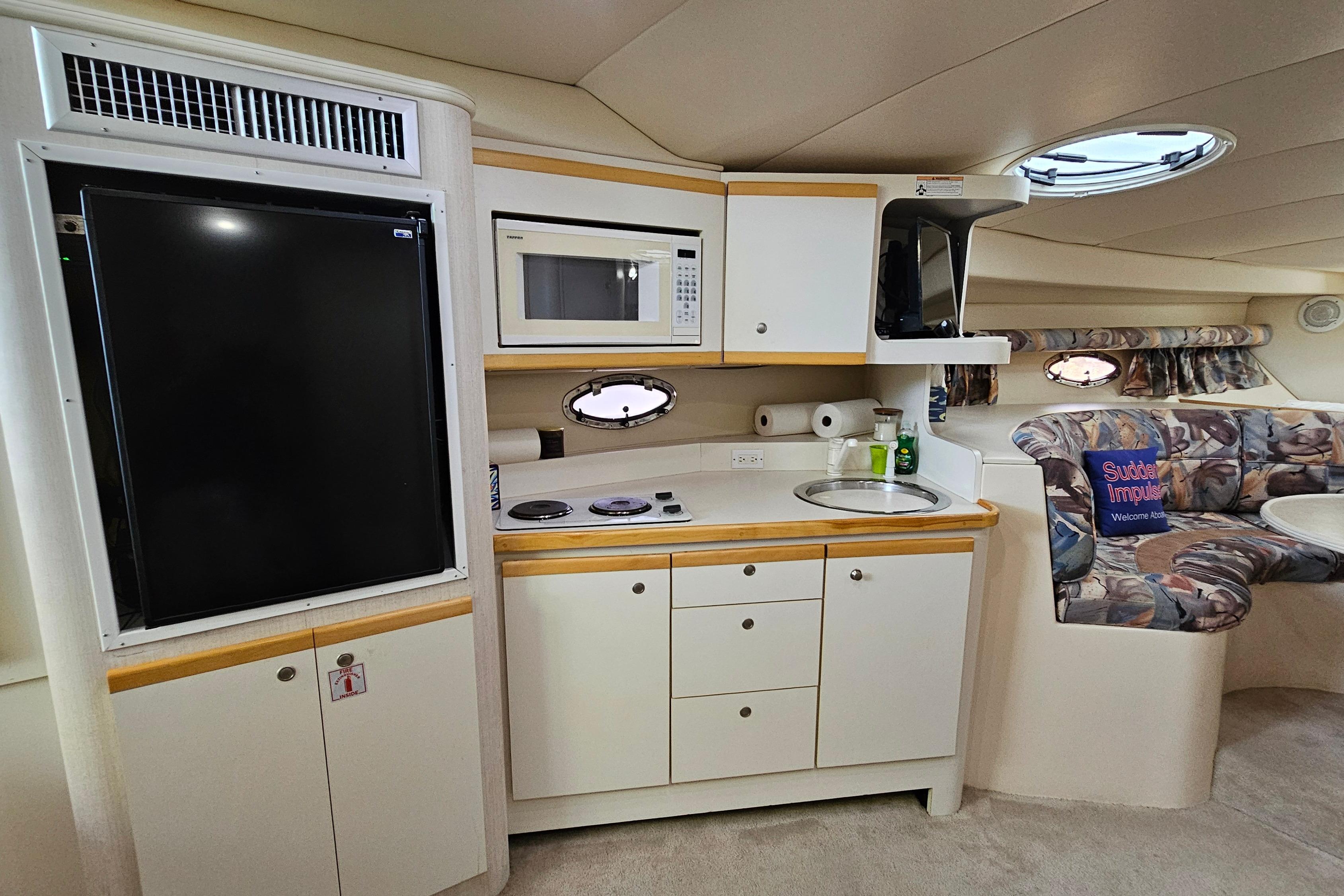 Interior of 1996 Cruisers Yachts 3570 Esprit with kitchenette and seating area.