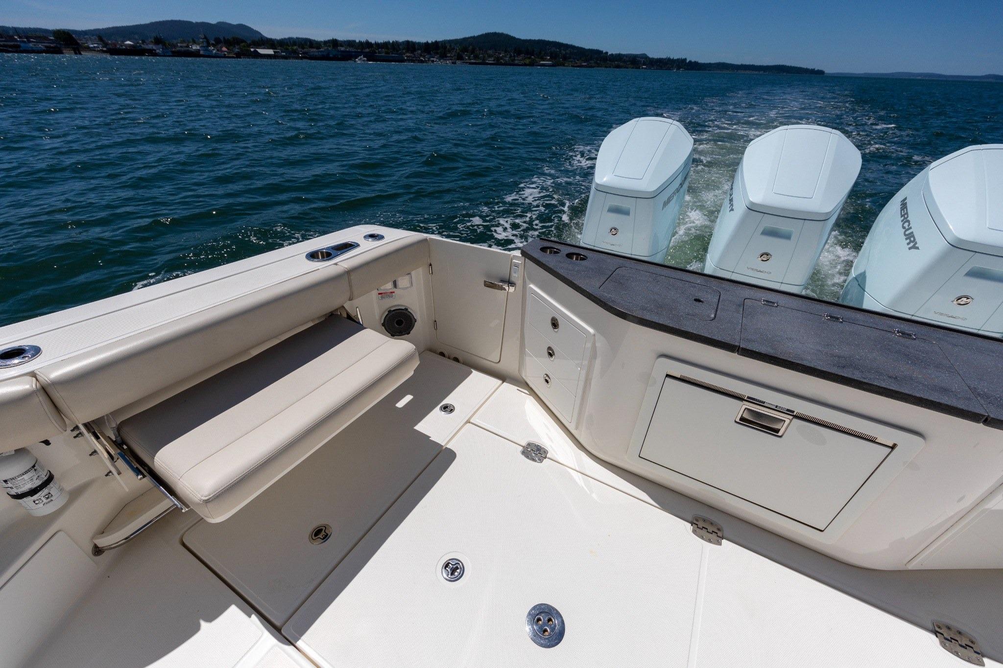 2023 Boston Whaler 405 Conquest boat deck with seating and triple Mercury engines.