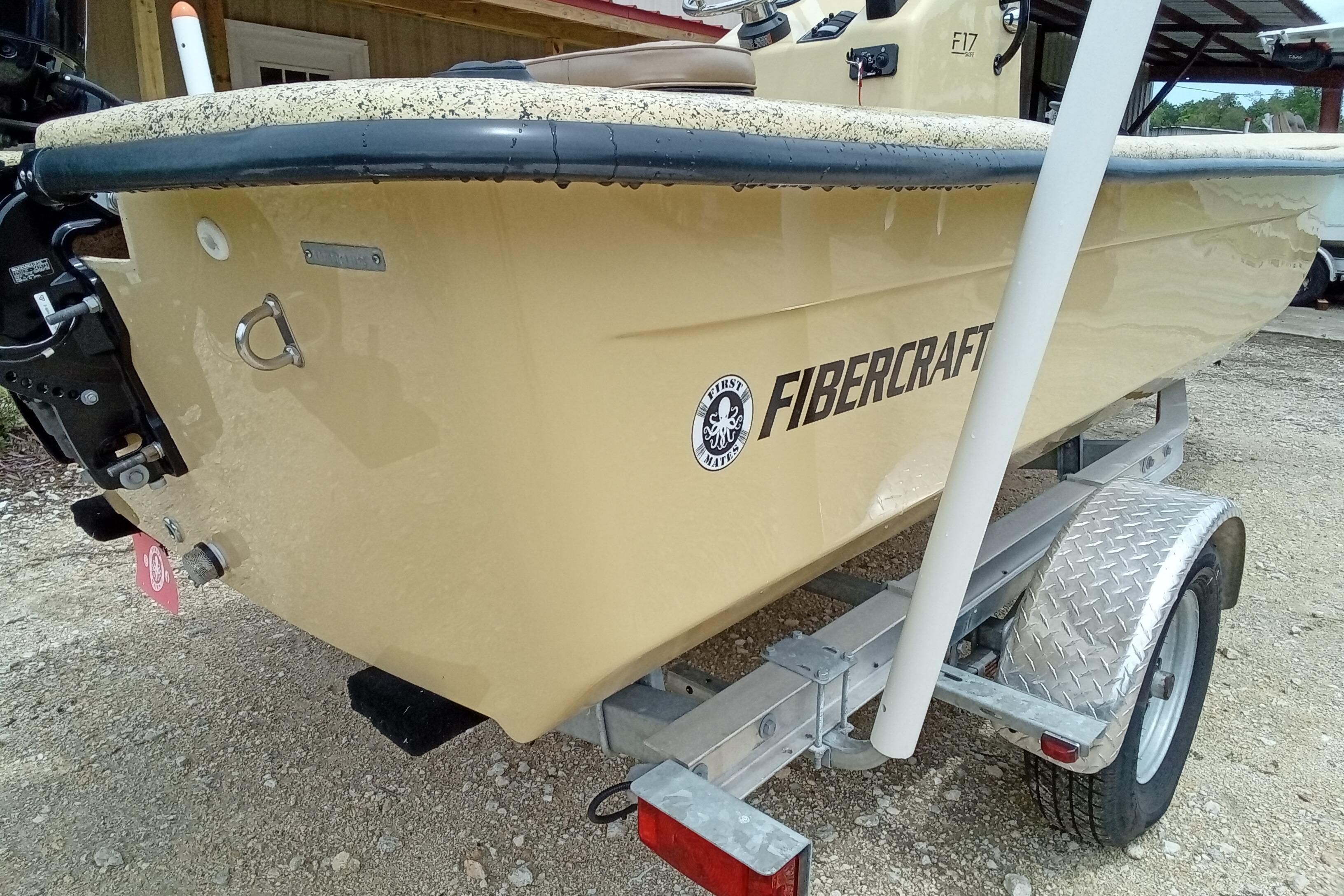 2025 Fibercraft F17 boat on trailer, beige color, rear view.
