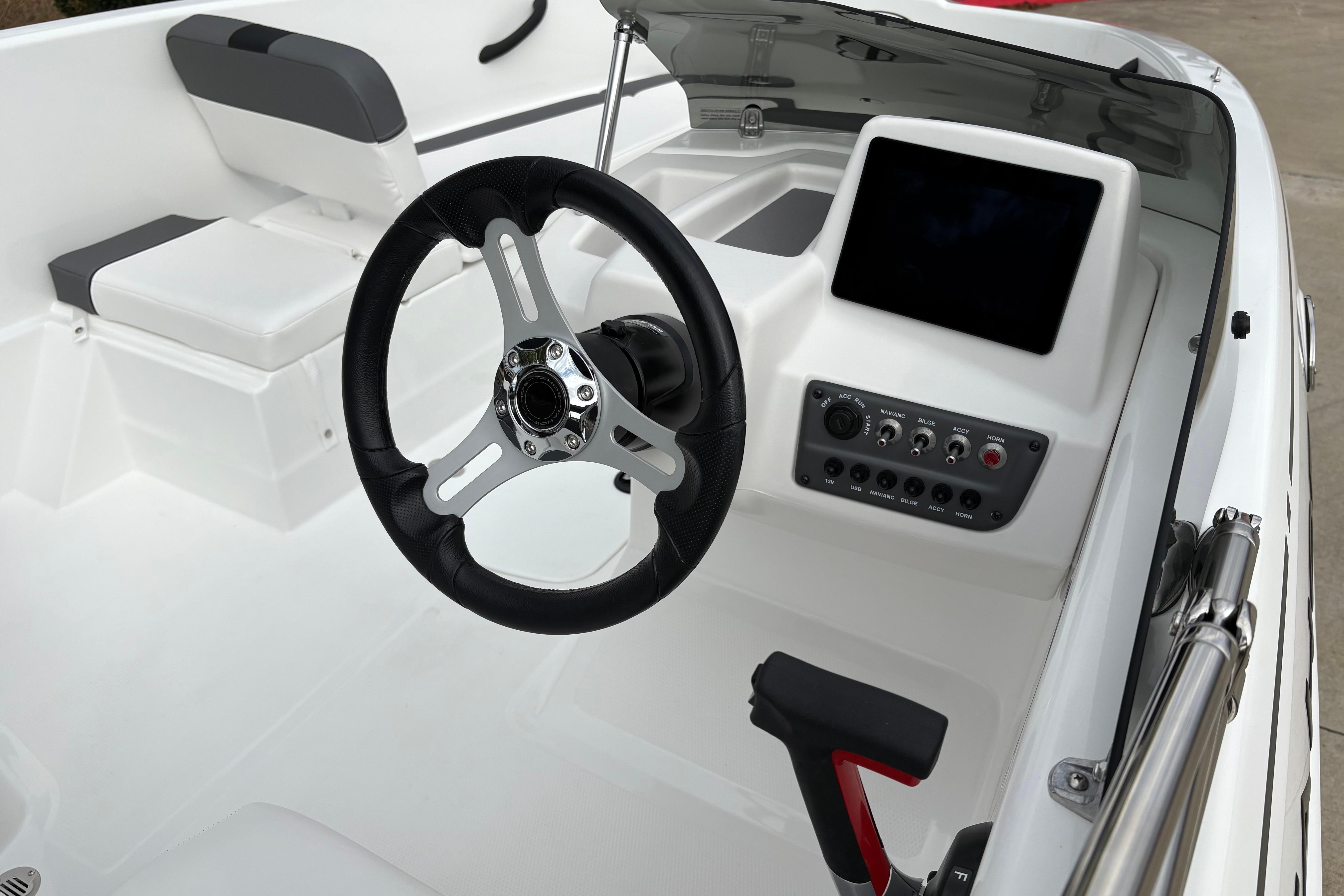 2025 Tahoe T16 boat interior with steering wheel and control panel.