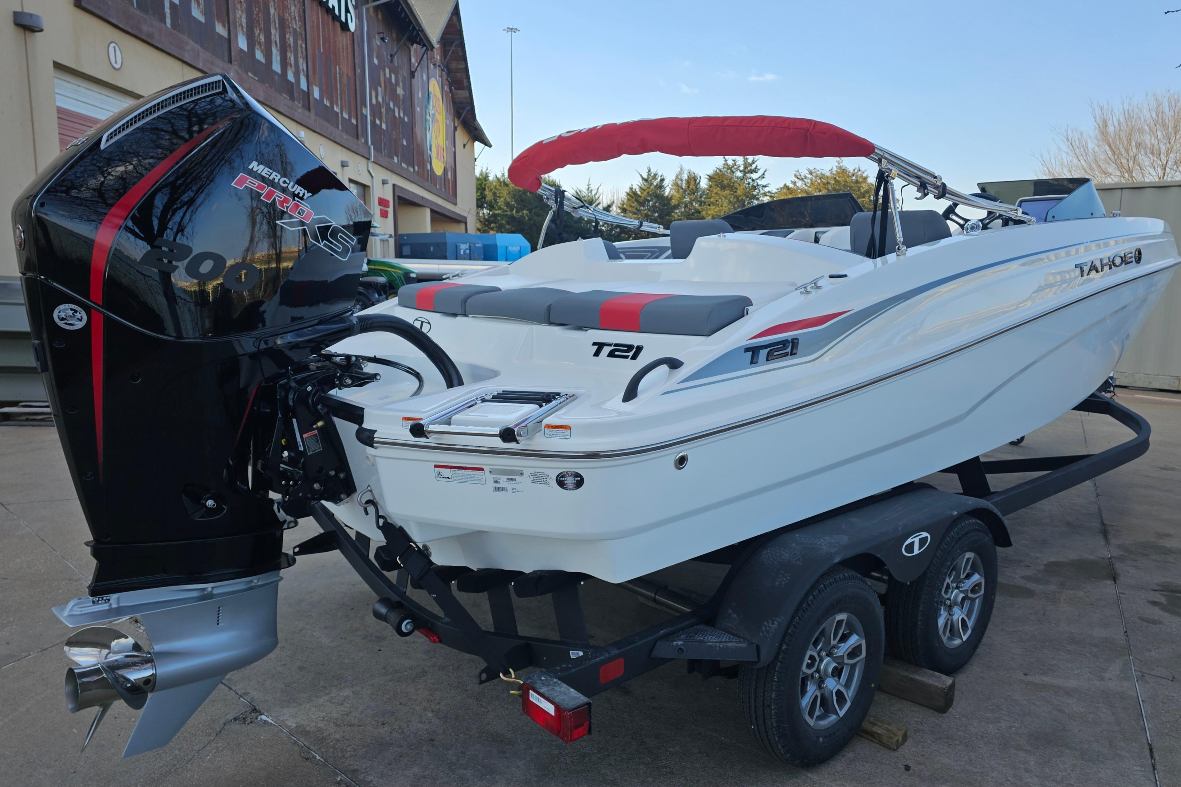 2026 Tahoe T21 boat on trailer with Mercury Pro XS engine, parked outdoors.