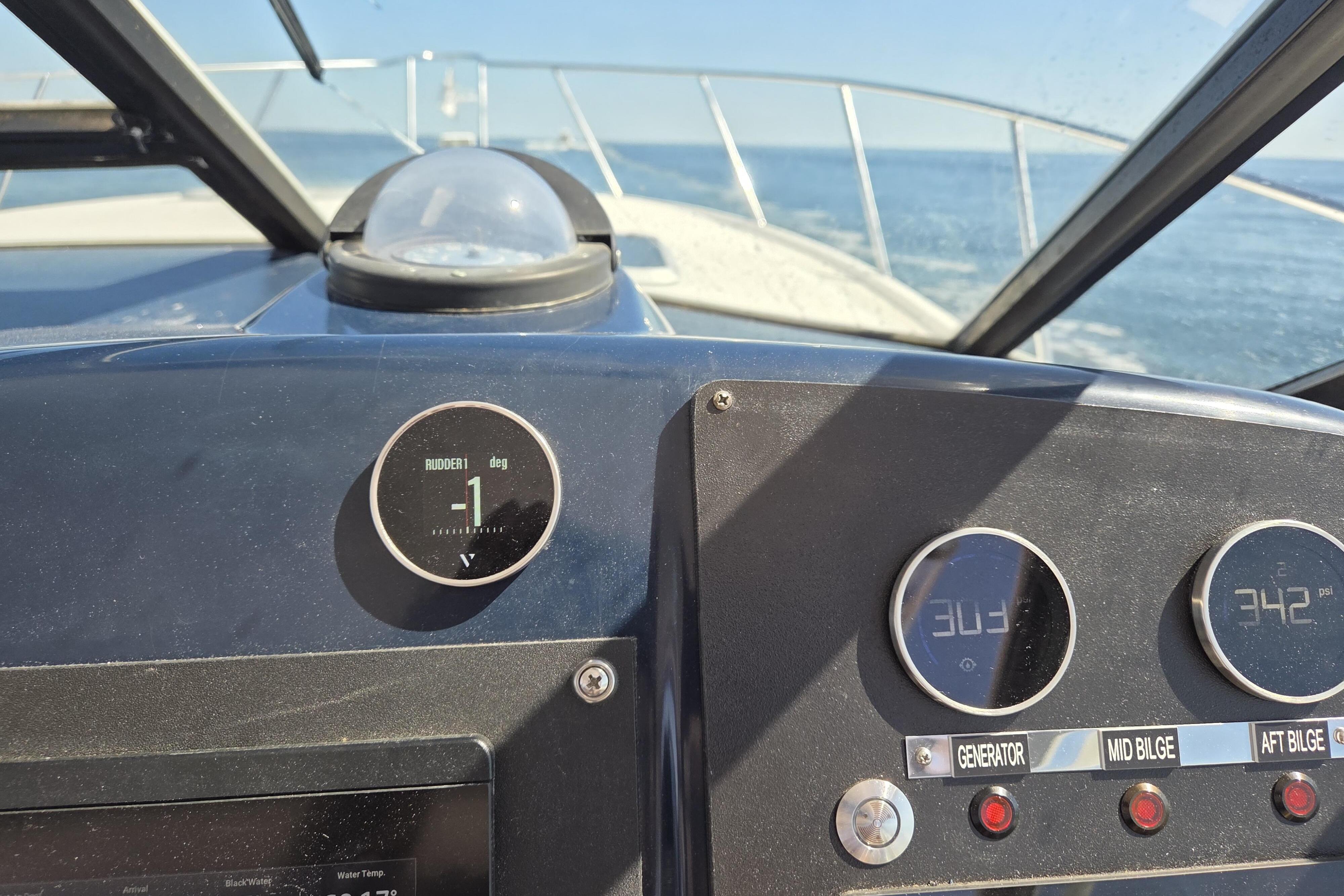 Dashboard view of a 1998 Tiara Yachts 3500 Open, showing navigation instruments at sea.