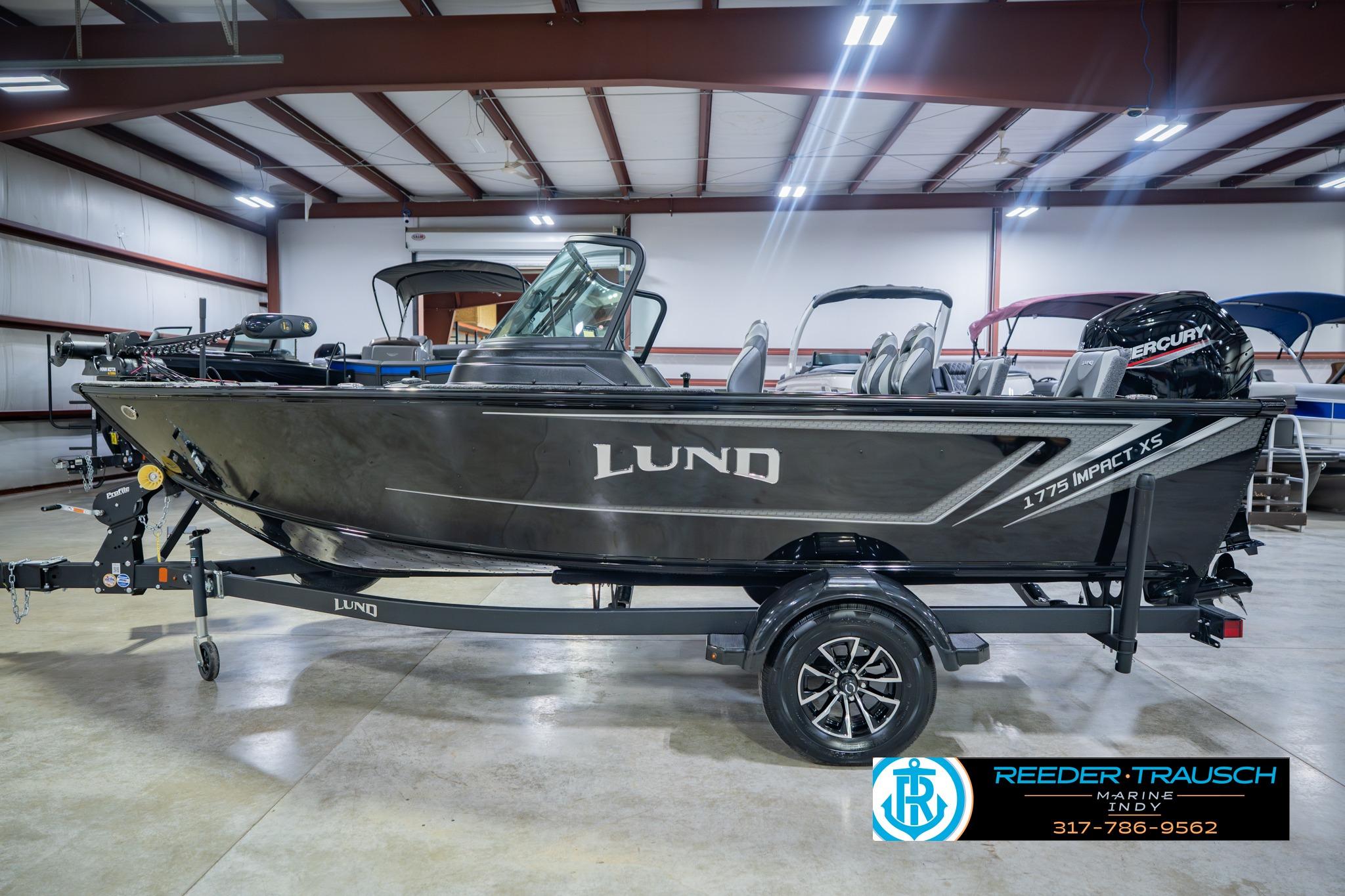 2026 Lund 1775 Impact XS boat in showroom, side view, on trailer.