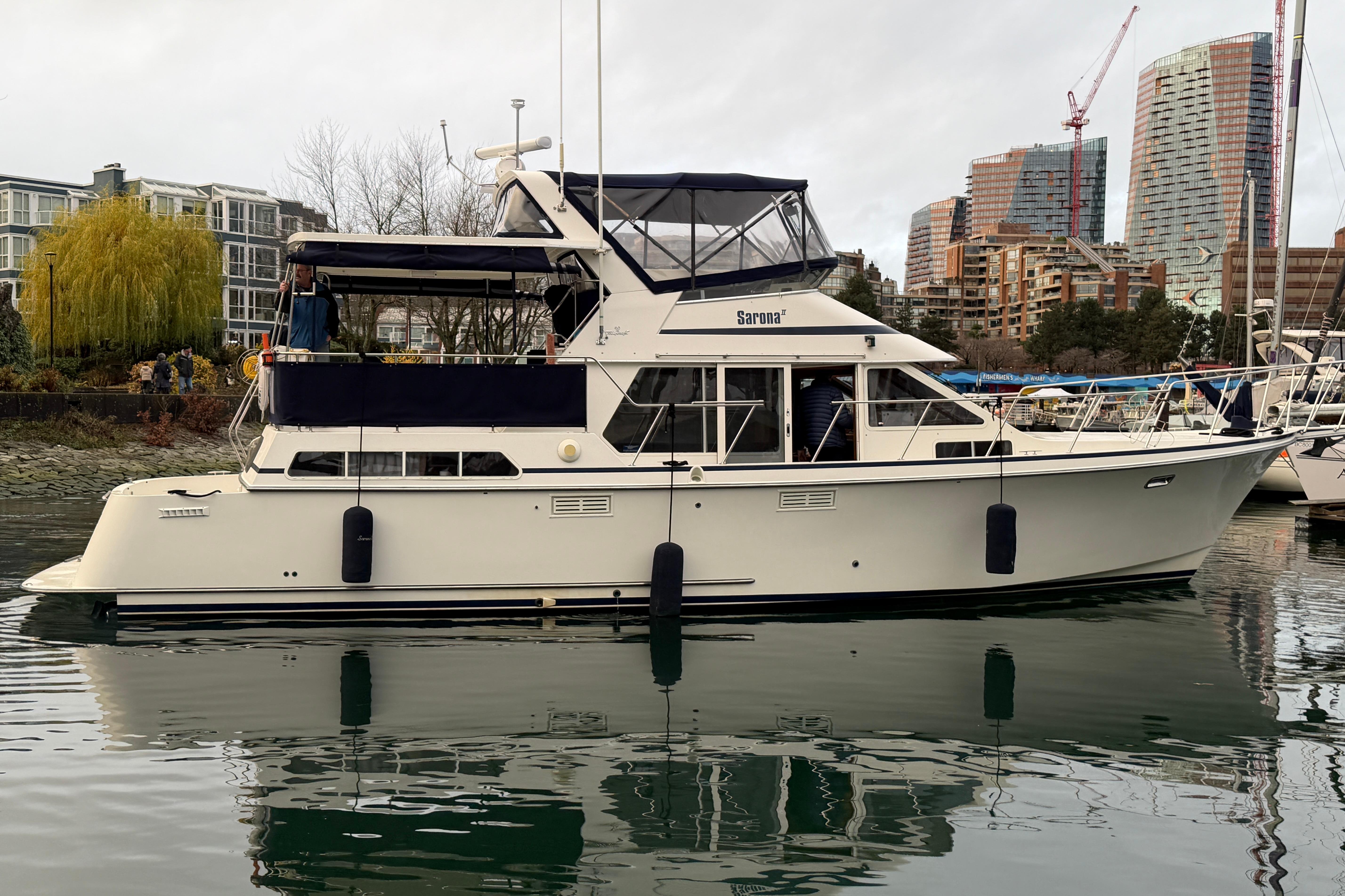 1994 Tollycraft 45 Cockpit Motor Yacht docked in urban marina setting.