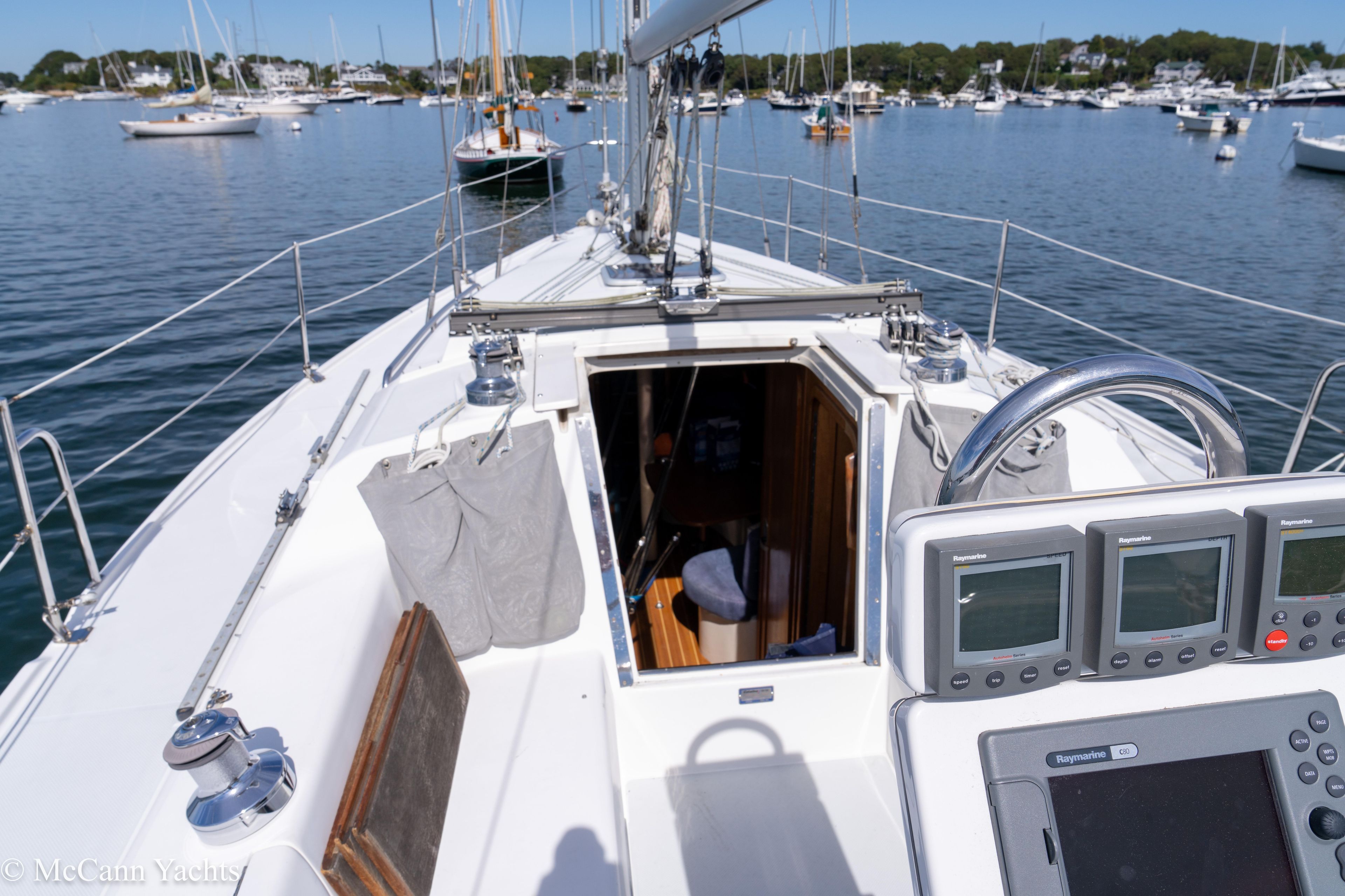2003 Catalina 320 sailboat cockpit with navigation instruments, open cabin, and marina view.