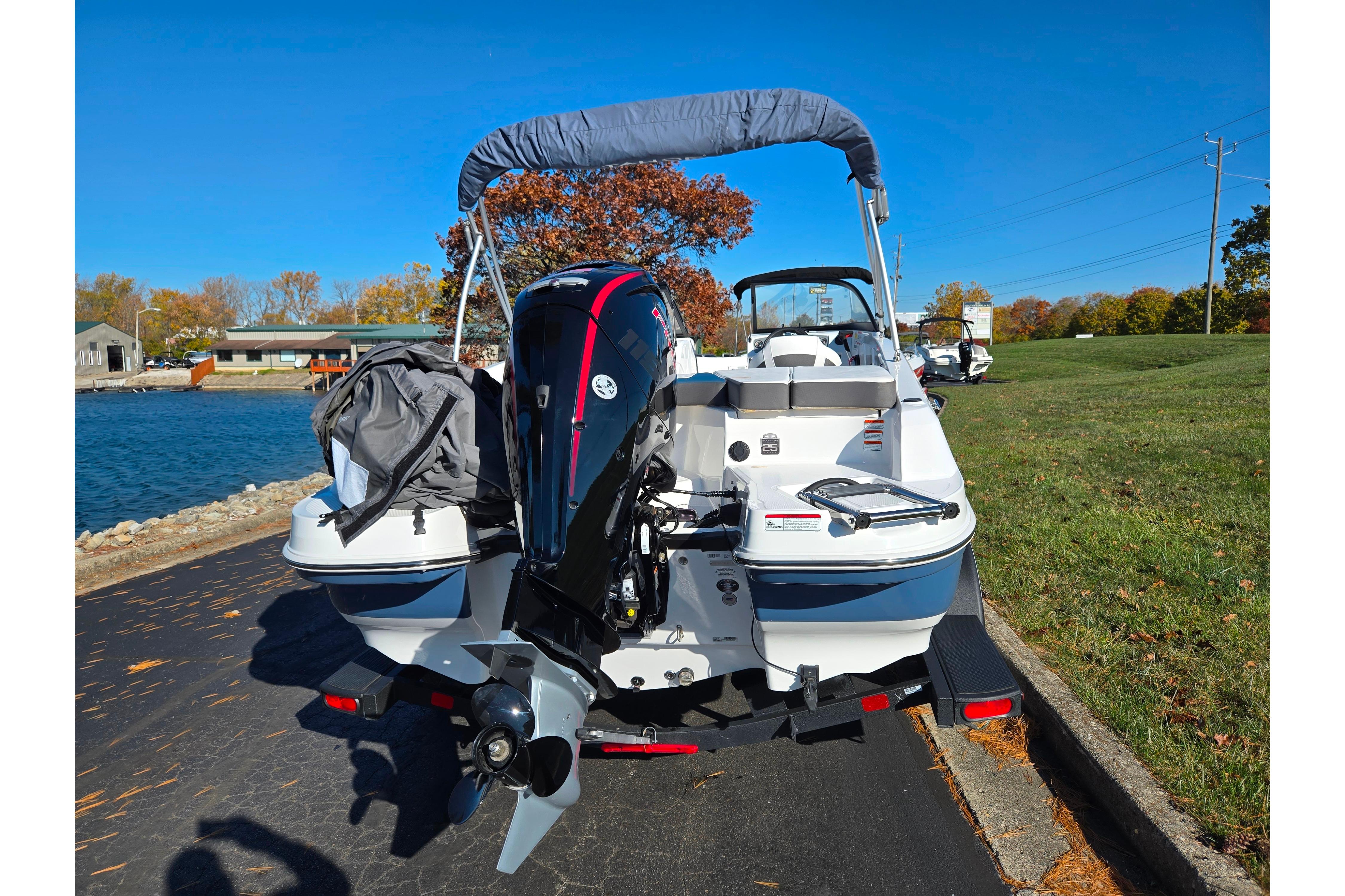2023 Tahoe 185 S boat with outboard motor, parked near a scenic lake.