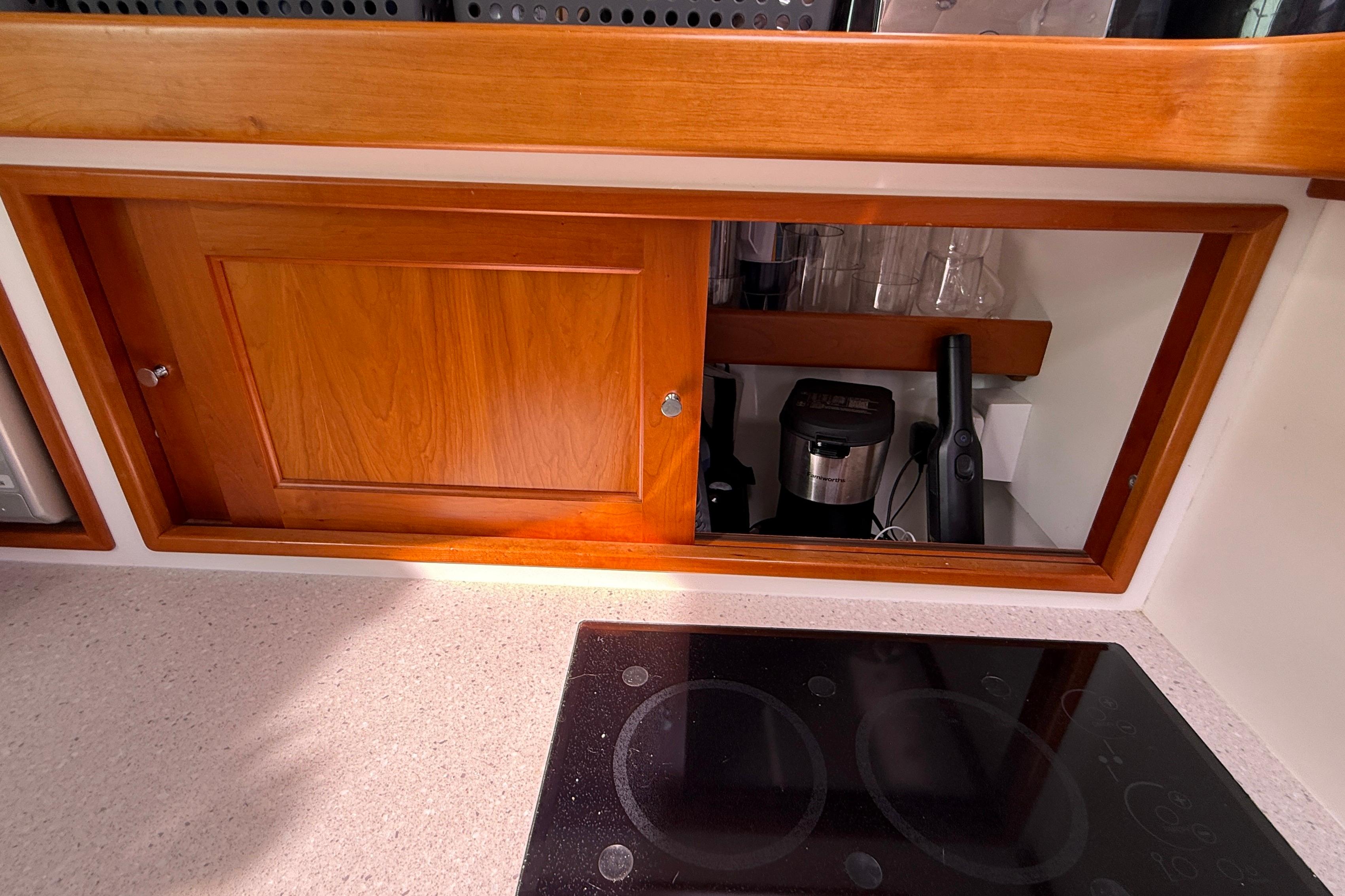 Wooden cabinet and electric stove in 2012 MJM 40z yacht kitchen.