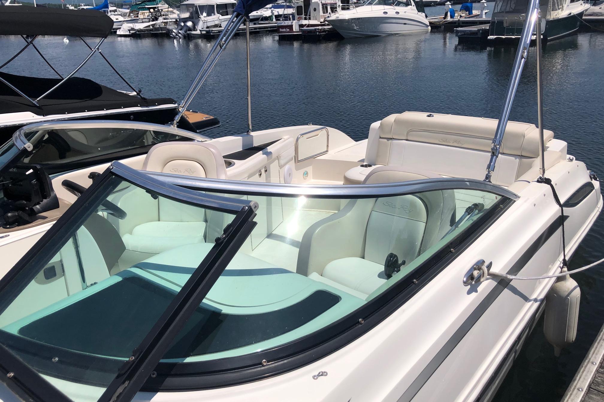 2013 Sea Ray 260 Sundeck boat docked at marina, featuring spacious seating and sleek design.