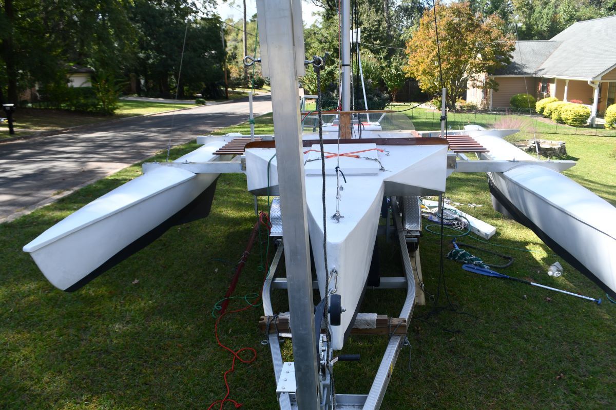Custom Strike 18 trimaran on trailer in garden, year 2020.