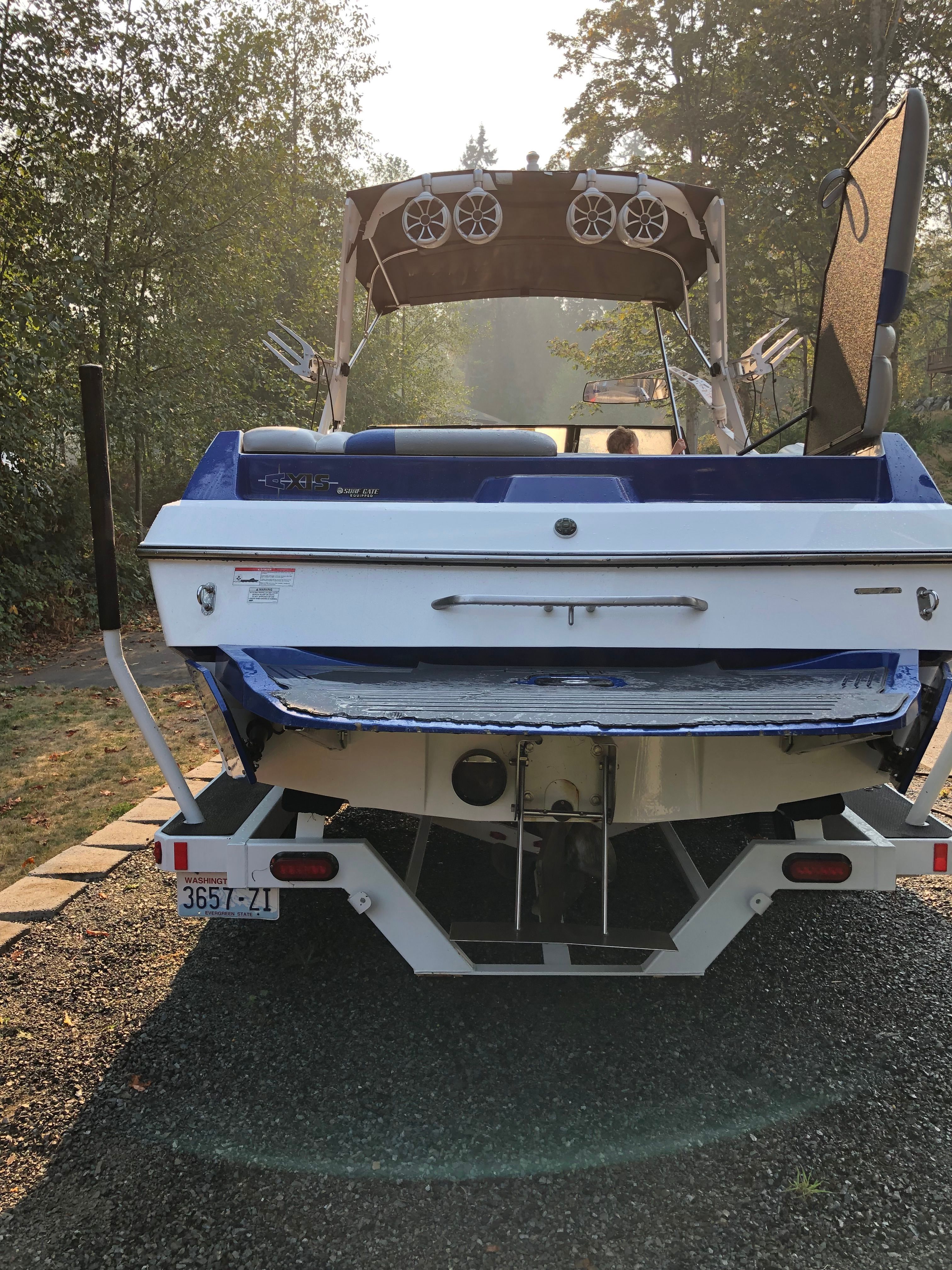 Rear view of a blue Custom a22 boat, year 2015, on a trailer.