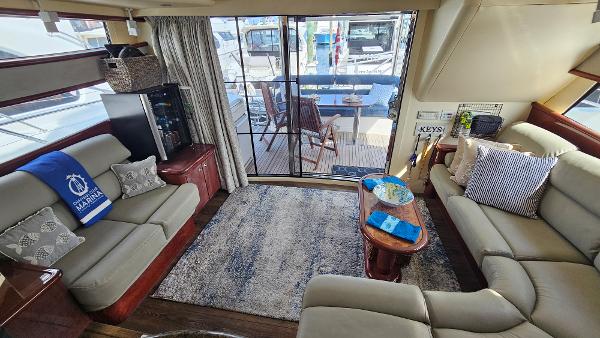 Luxurious interior of 2005 Neptunus 56 Flybridge yacht with elegant seating and decor.
