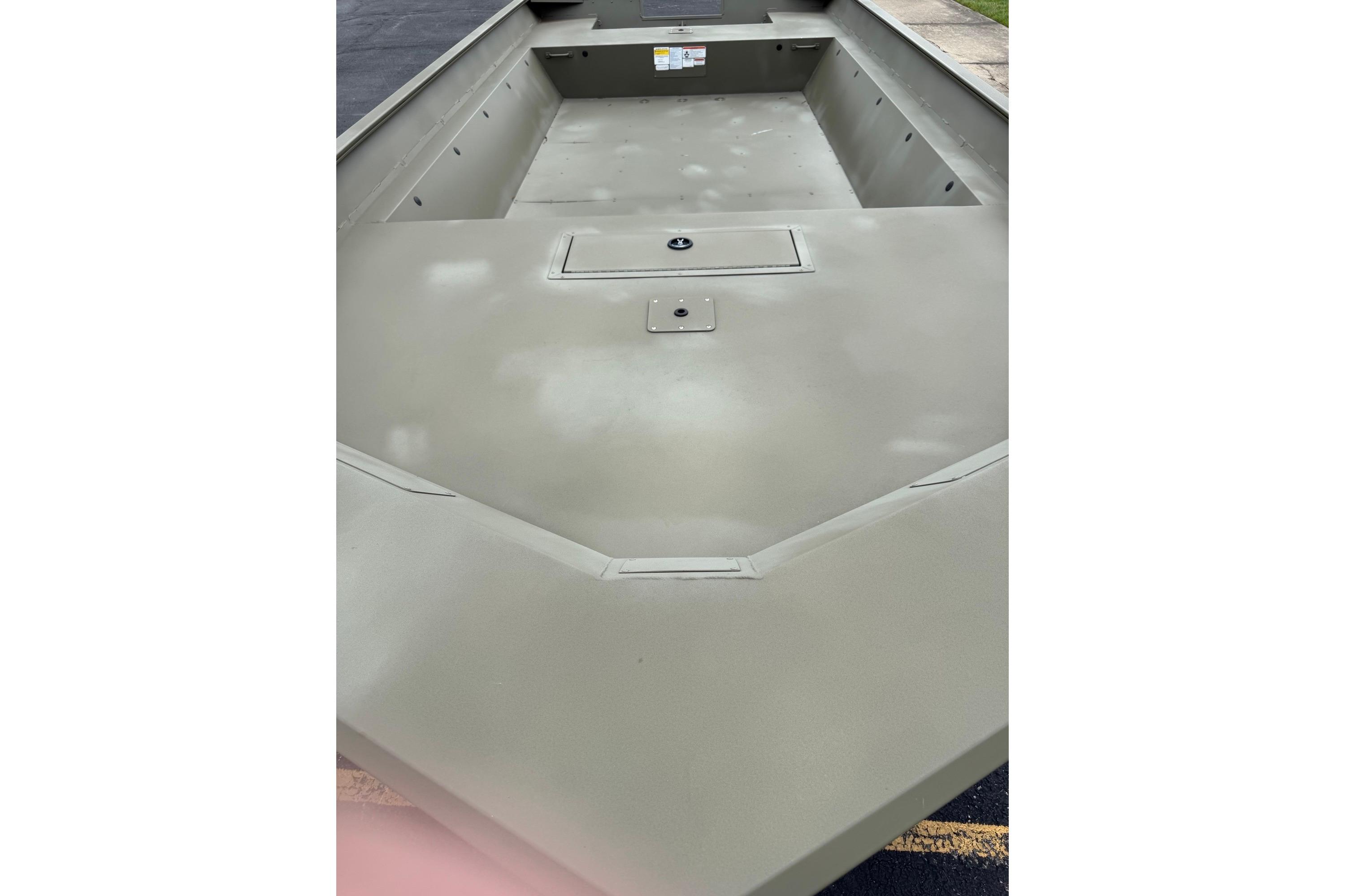 2025 Tracker Grizzly 2072 Utility boat interior, showcasing spacious deck and storage compartment.
