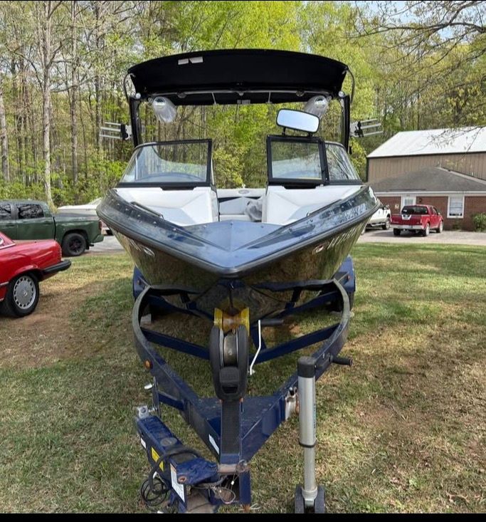 2010 Tigé Z1 boat parked on trailer outdoors.