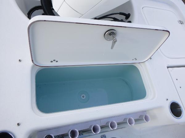 2025 Sea Pro 230 Bay boat livewell with open lid and key.