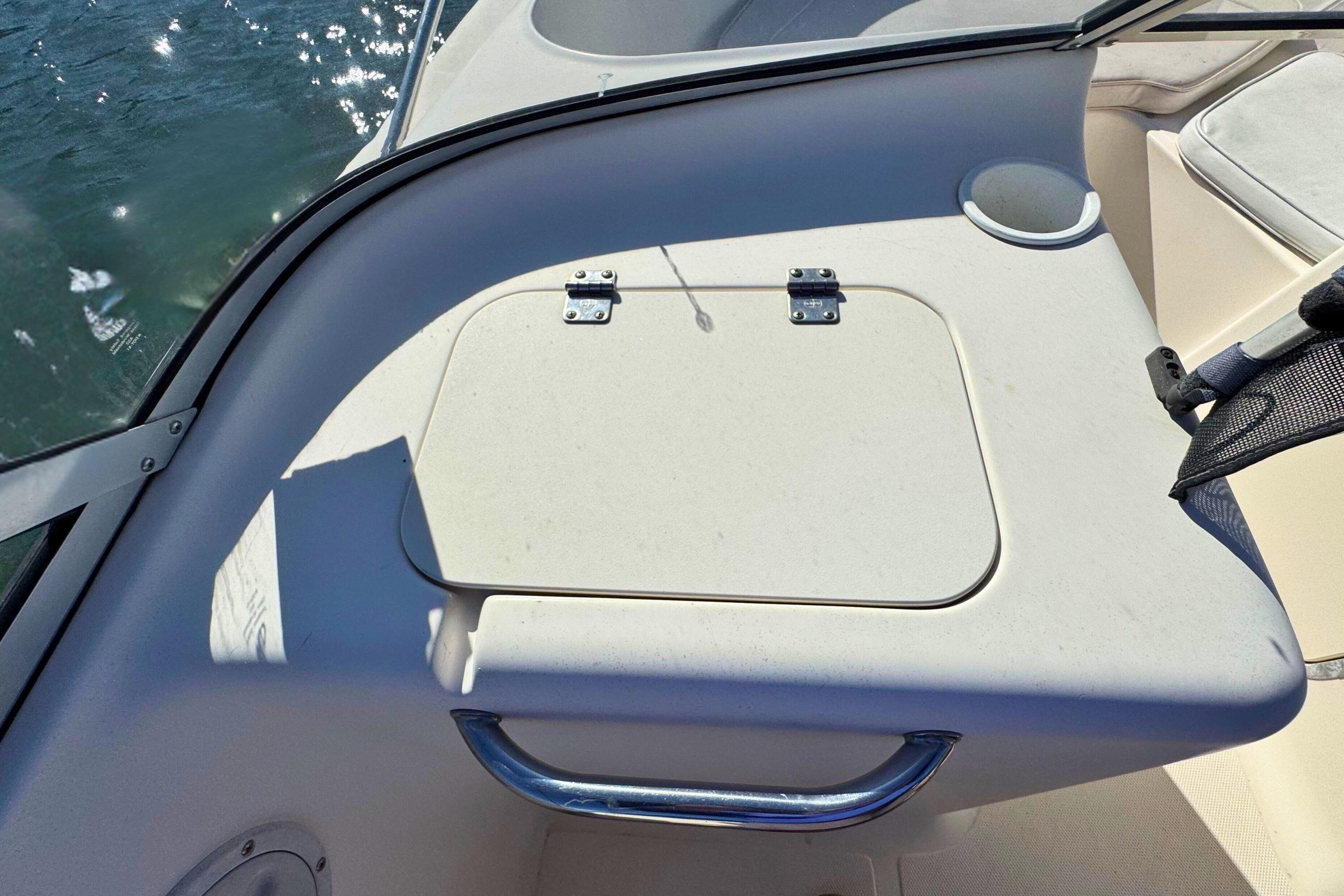 2002 Sea Hunt Escape 200 boat interior with storage compartment and handle.