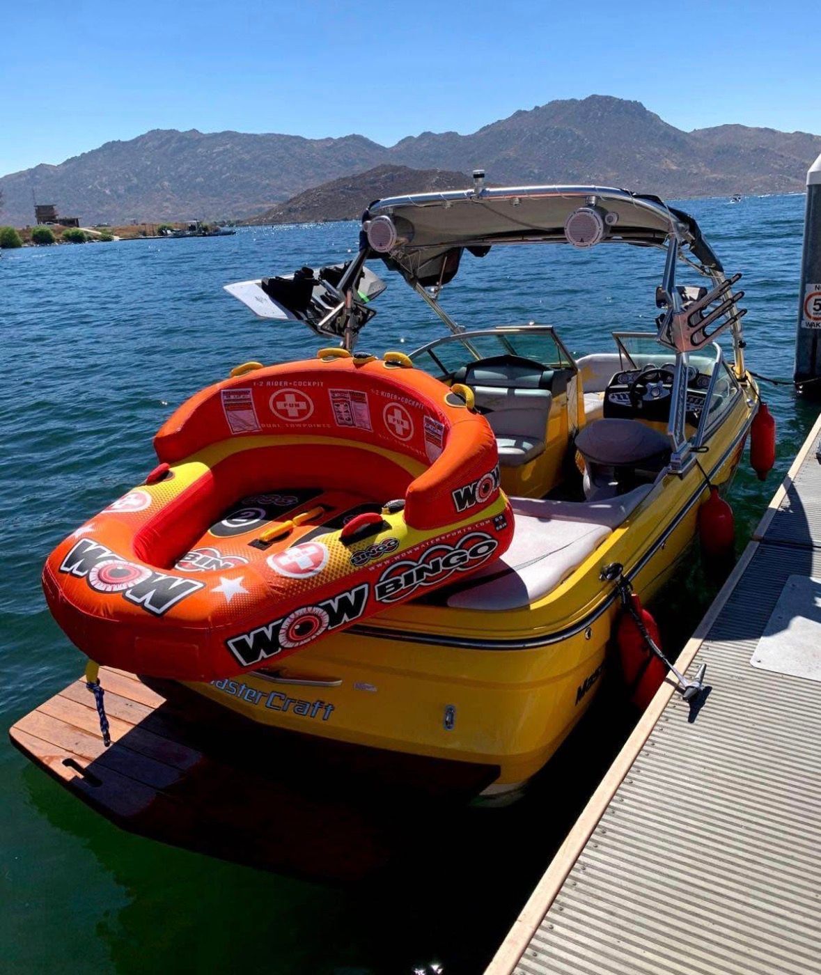 2007 MasterCraft X-2 boat with inflatable tube on a lake.