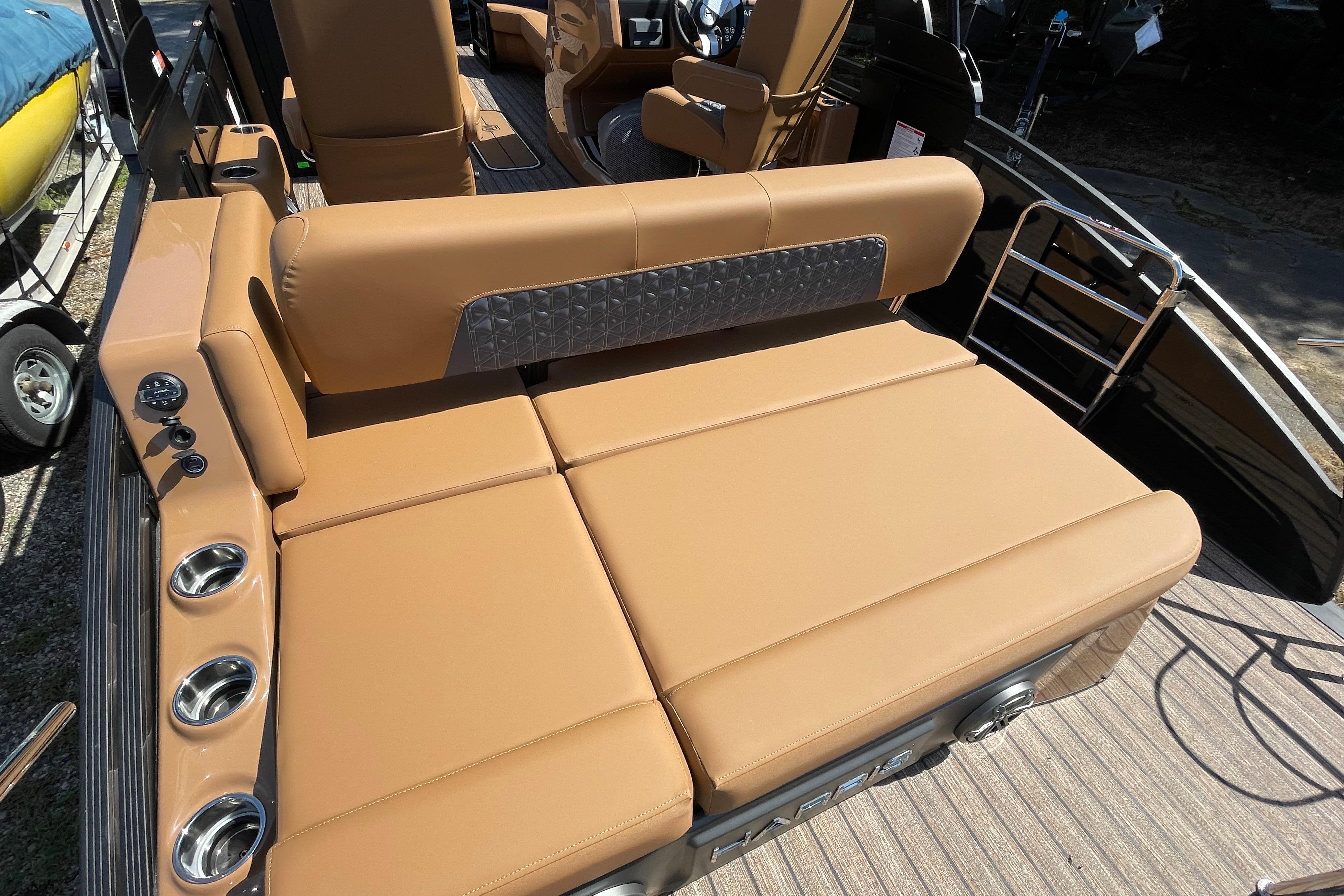 Luxurious seating on 2026 Harris Solstice 250 SLDH boat with tan upholstery and cup holders.