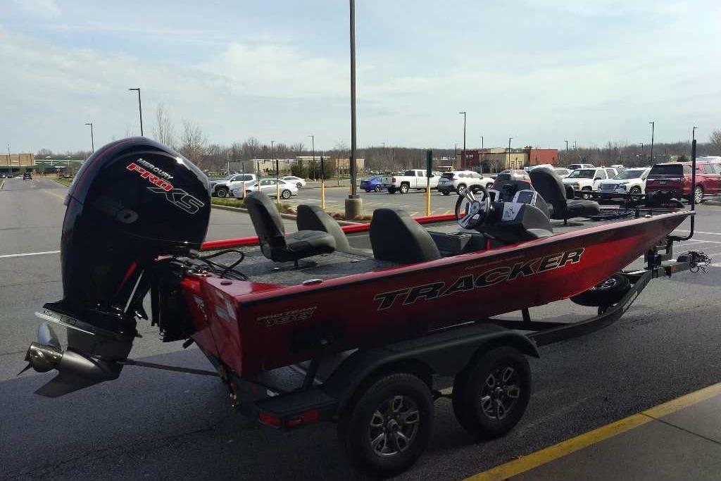 2026 Tracker Pro Team 195 boat on trailer in parking lot.