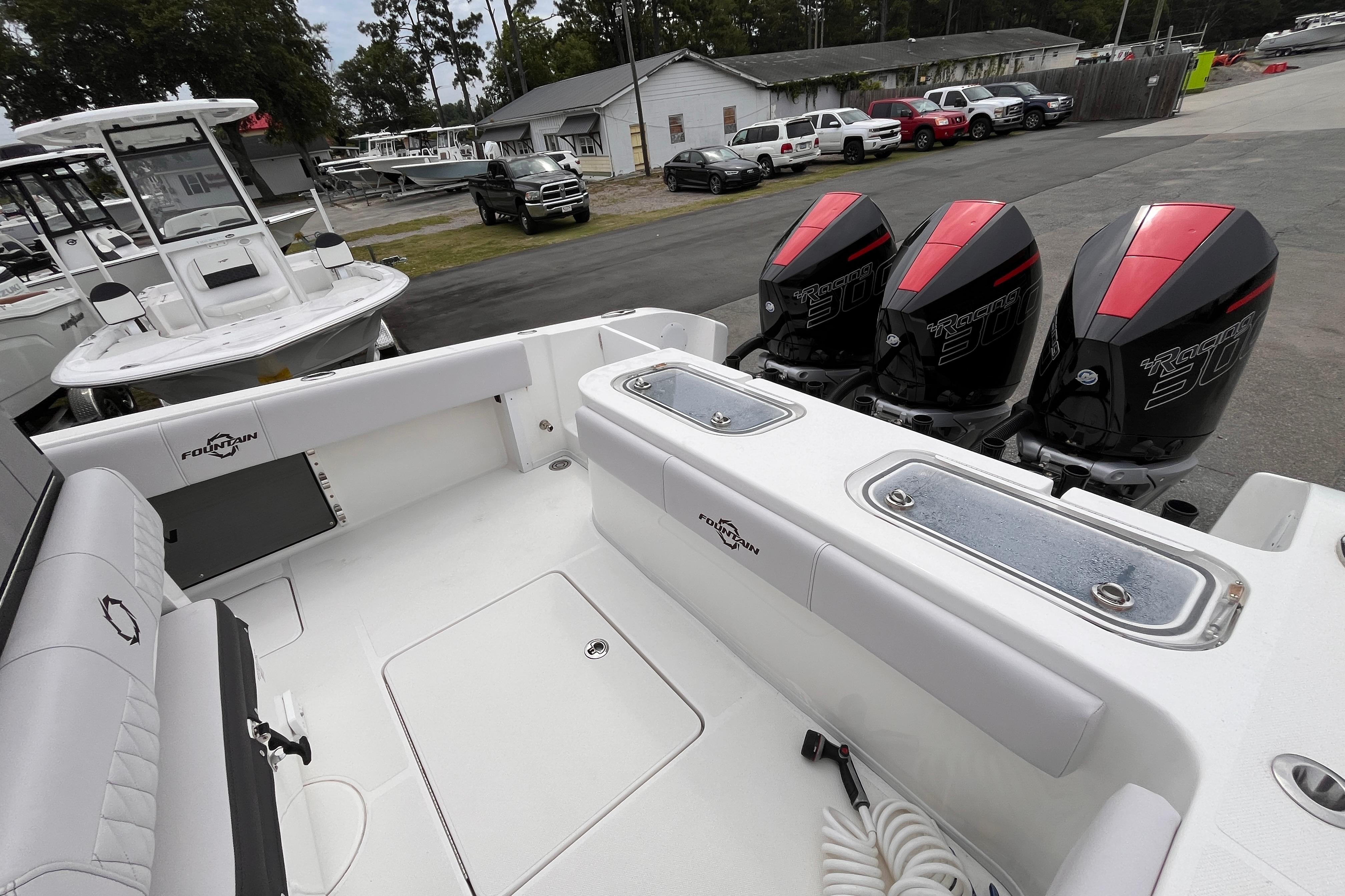 2024 Fountain 34 Tournament Edition boat with triple outboard engines, docked at a marina.