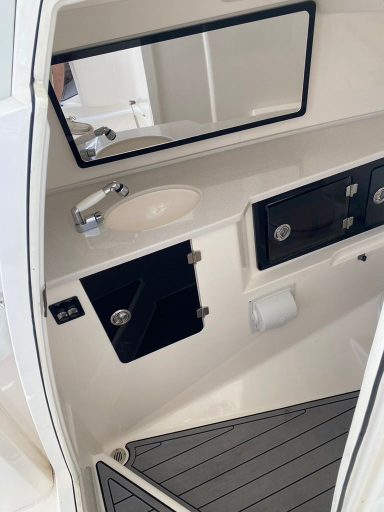 Interior of 2023 Cobia 330 yacht with sink and storage.