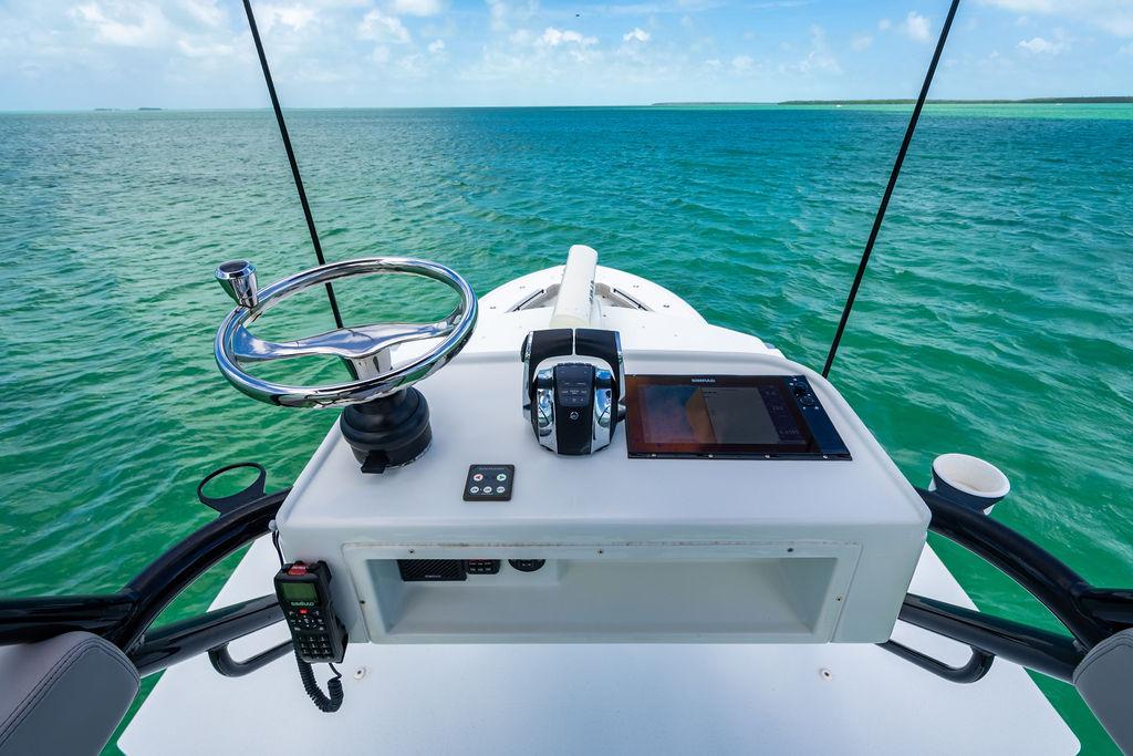 2015 Yellowfin CC boat helm with ocean view, featuring steering wheel and navigation controls.
