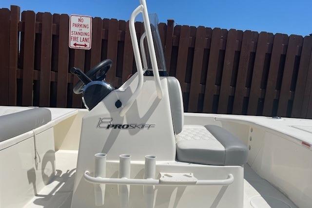 2026 Mako 18 Pro Skiff boat interior with steering console and seating.