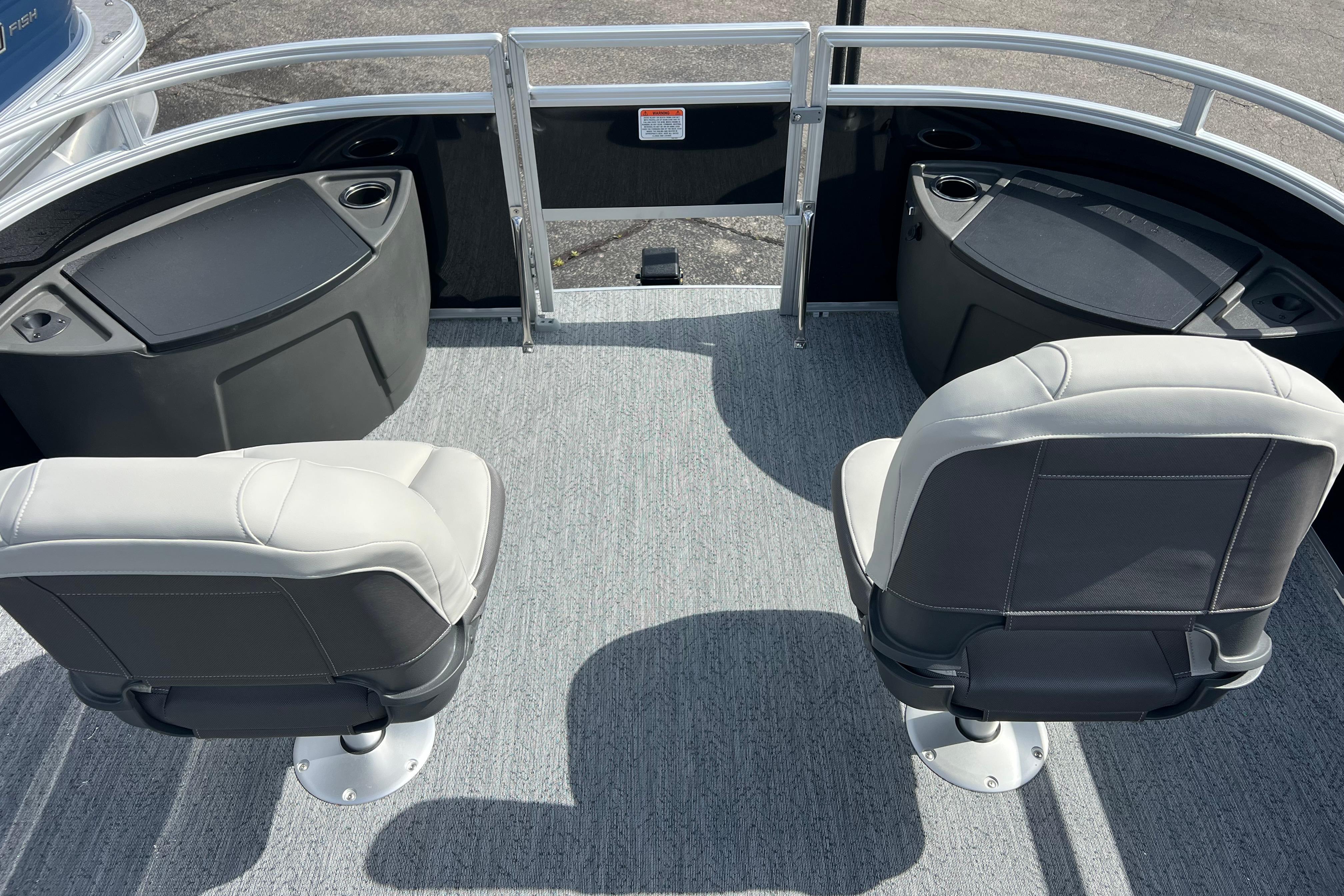 2026 Sun Tracker Fishin' Barge 22 DLX interior with two swivel seats and storage compartments.