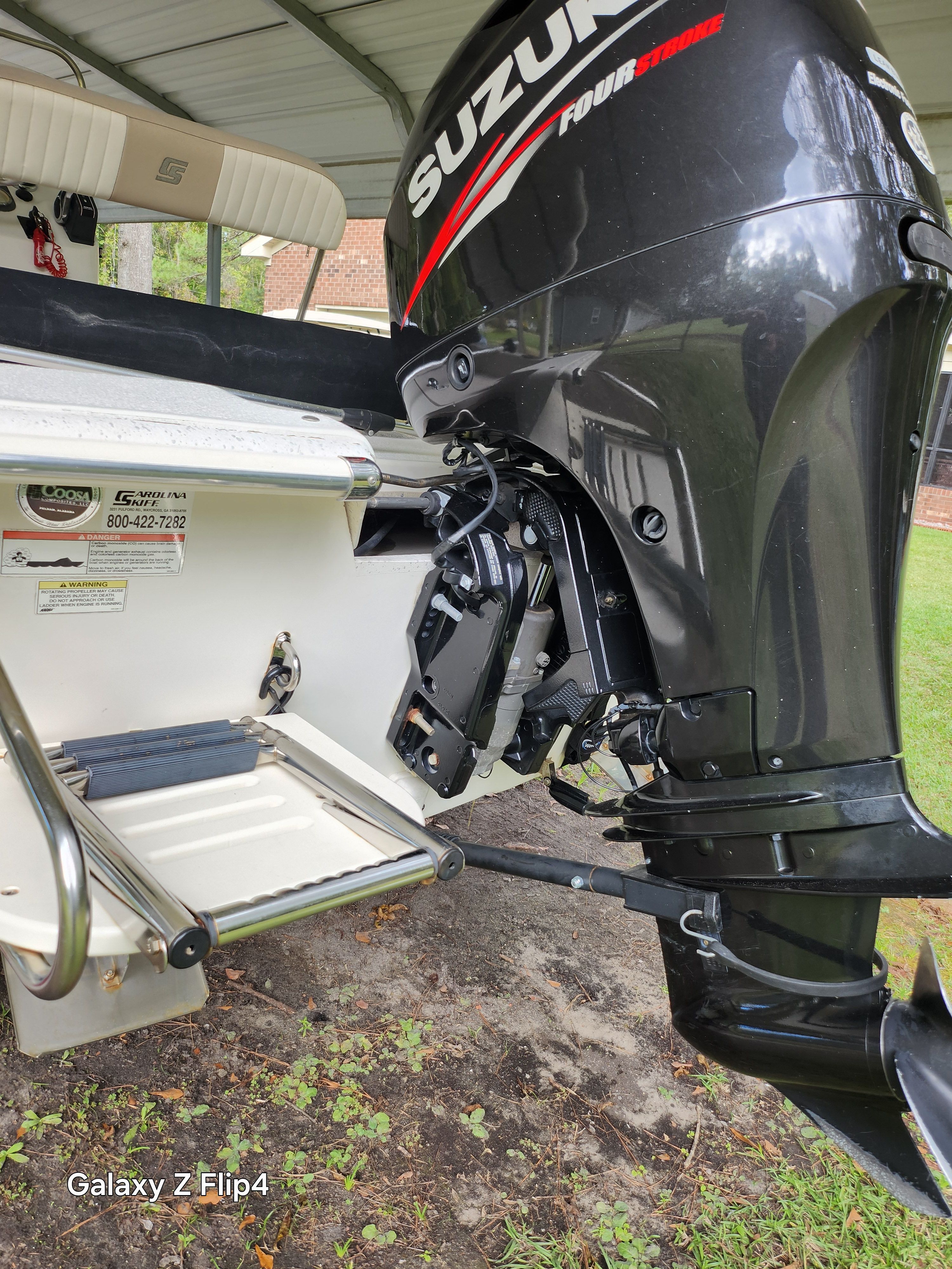 2013 Carolina Skiff JVX18CC with Suzuki four-stroke outboard motor and swim ladder.