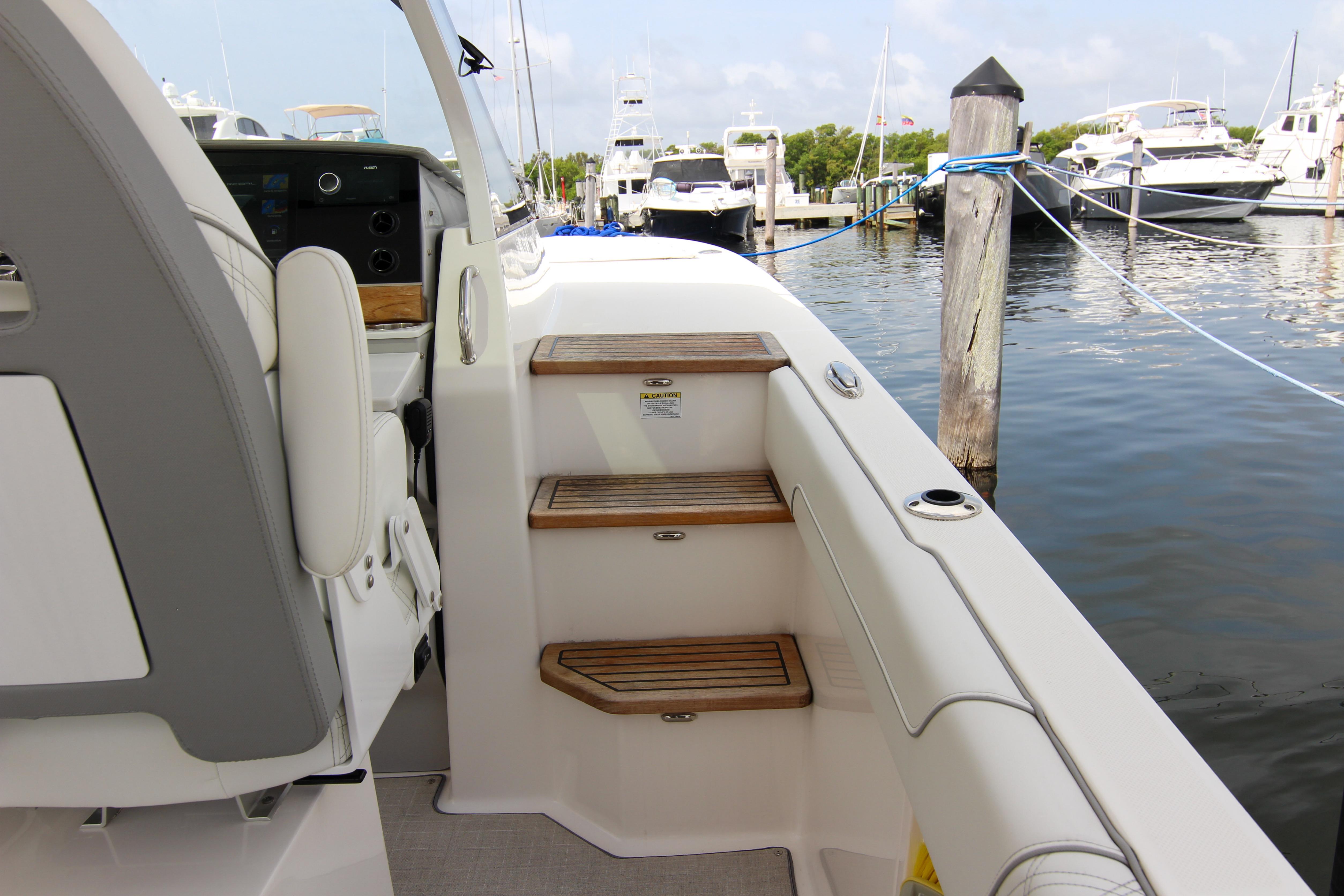 2023 Regal 38 SAV boat interior with wooden steps at marina.