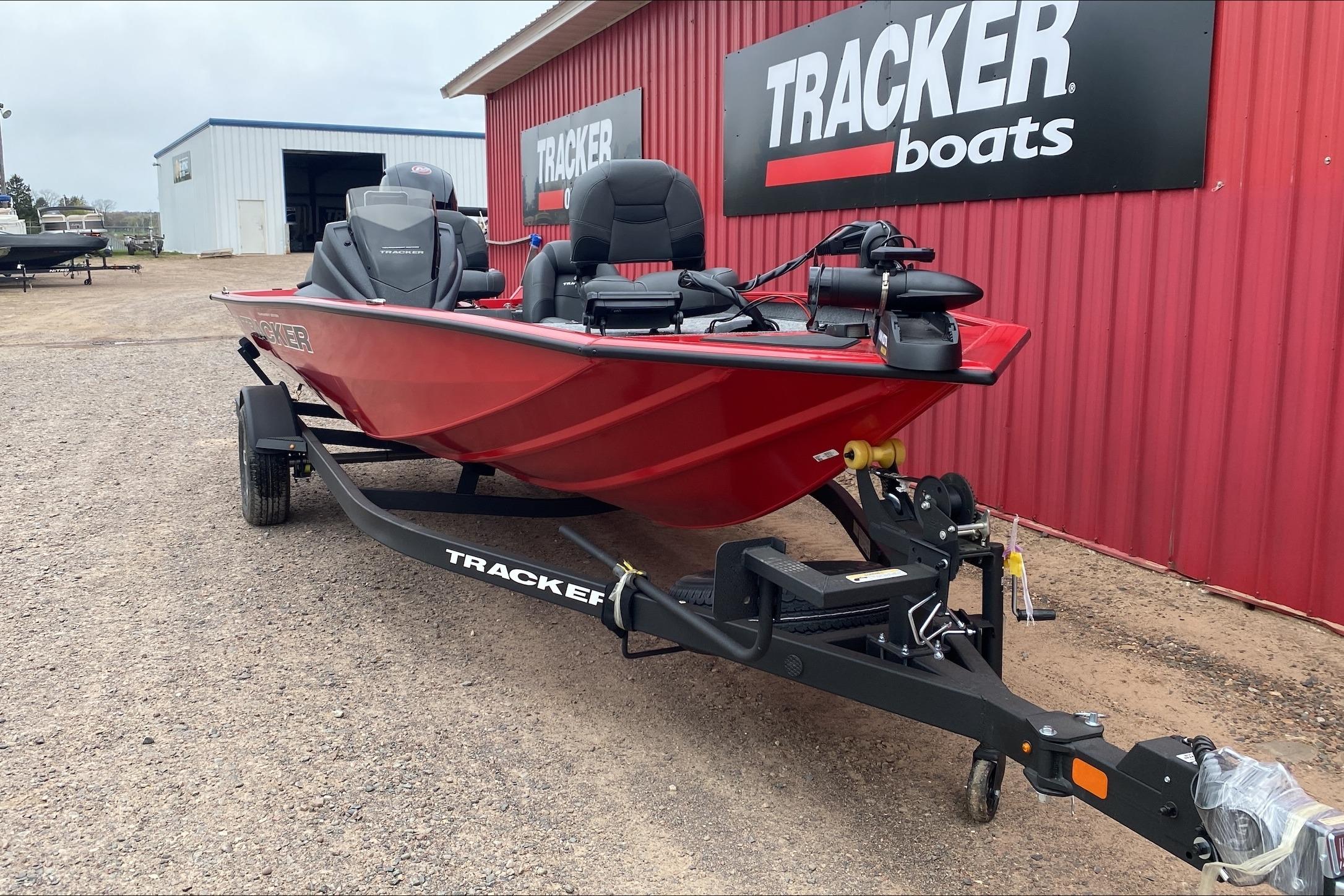 2026 Tracker Pro Team 195 boat on trailer, parked outside Tracker Boats dealership.