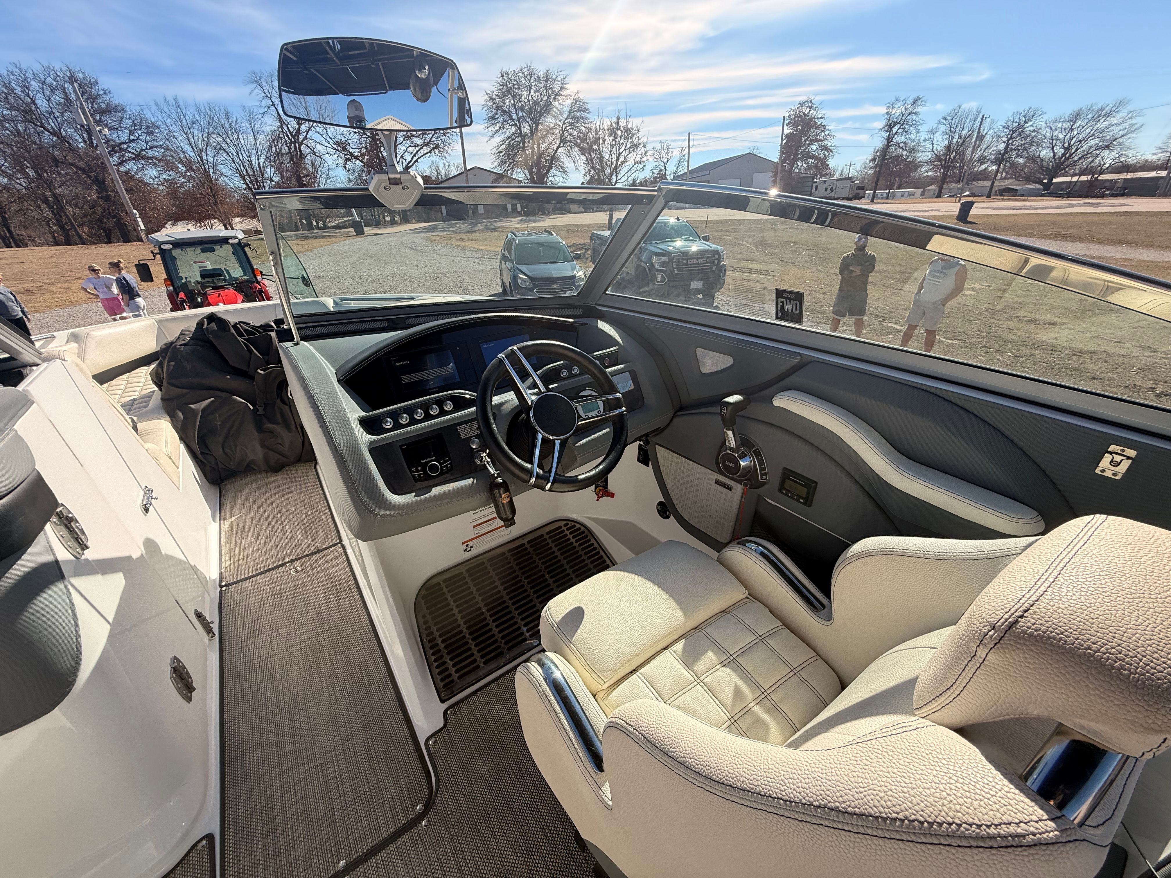The image shows the cockpit of a 2019 Cobalt R7 Surf boat with a sleek steering wheel and modern instruments.