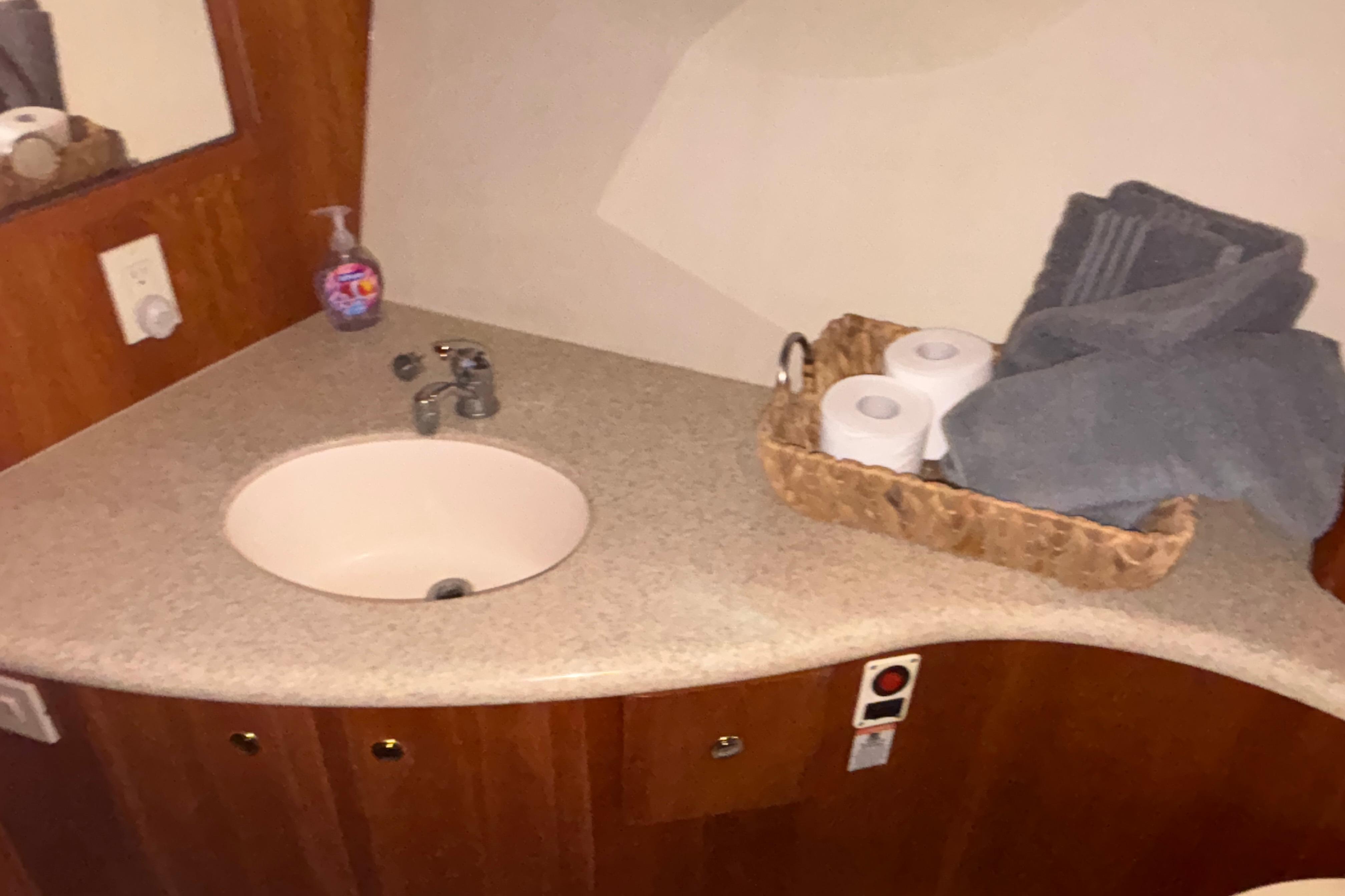 2001 Silverton 410 Sport Bridge bathroom with sink, toiletries, and towels.