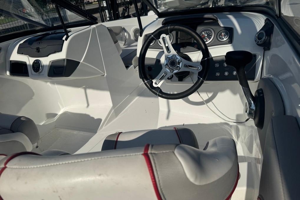 Interior of a 2018 Tahoe 700 TF boat, featuring steering wheel and dashboard controls.
