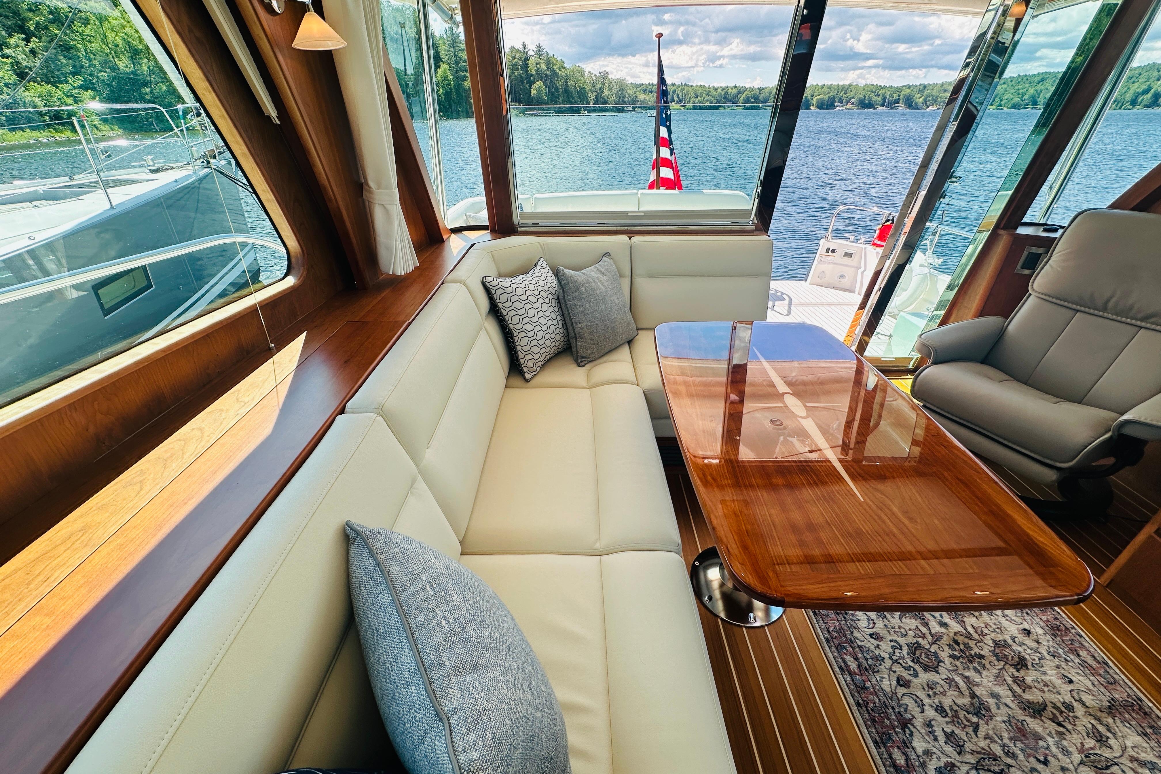 Luxurious interior of 2025 Sabre 48 Salon Express yacht with elegant seating and scenic water view.