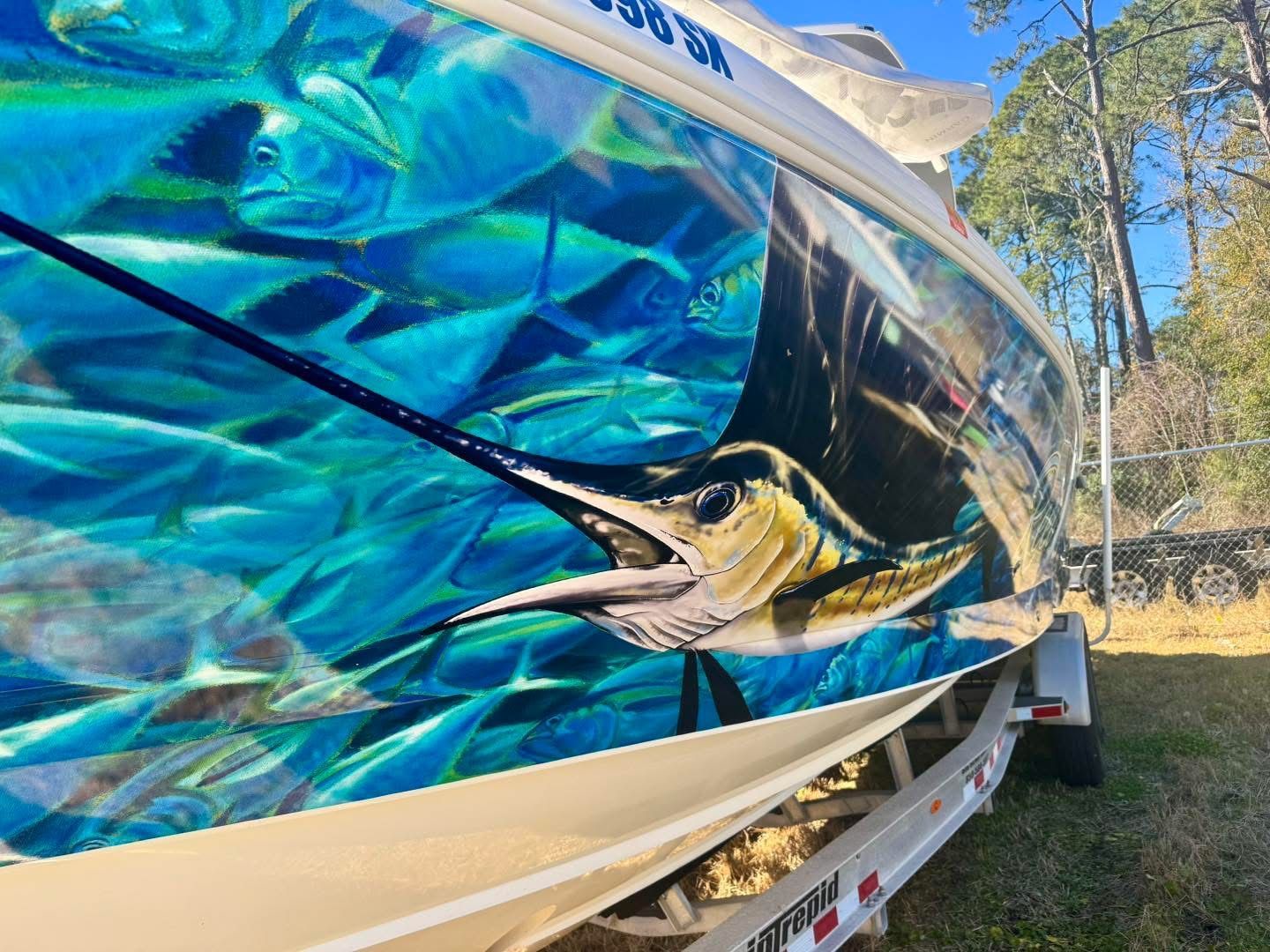 Intrepid 327 Nomad 2021 with vibrant fish design on the hull.
