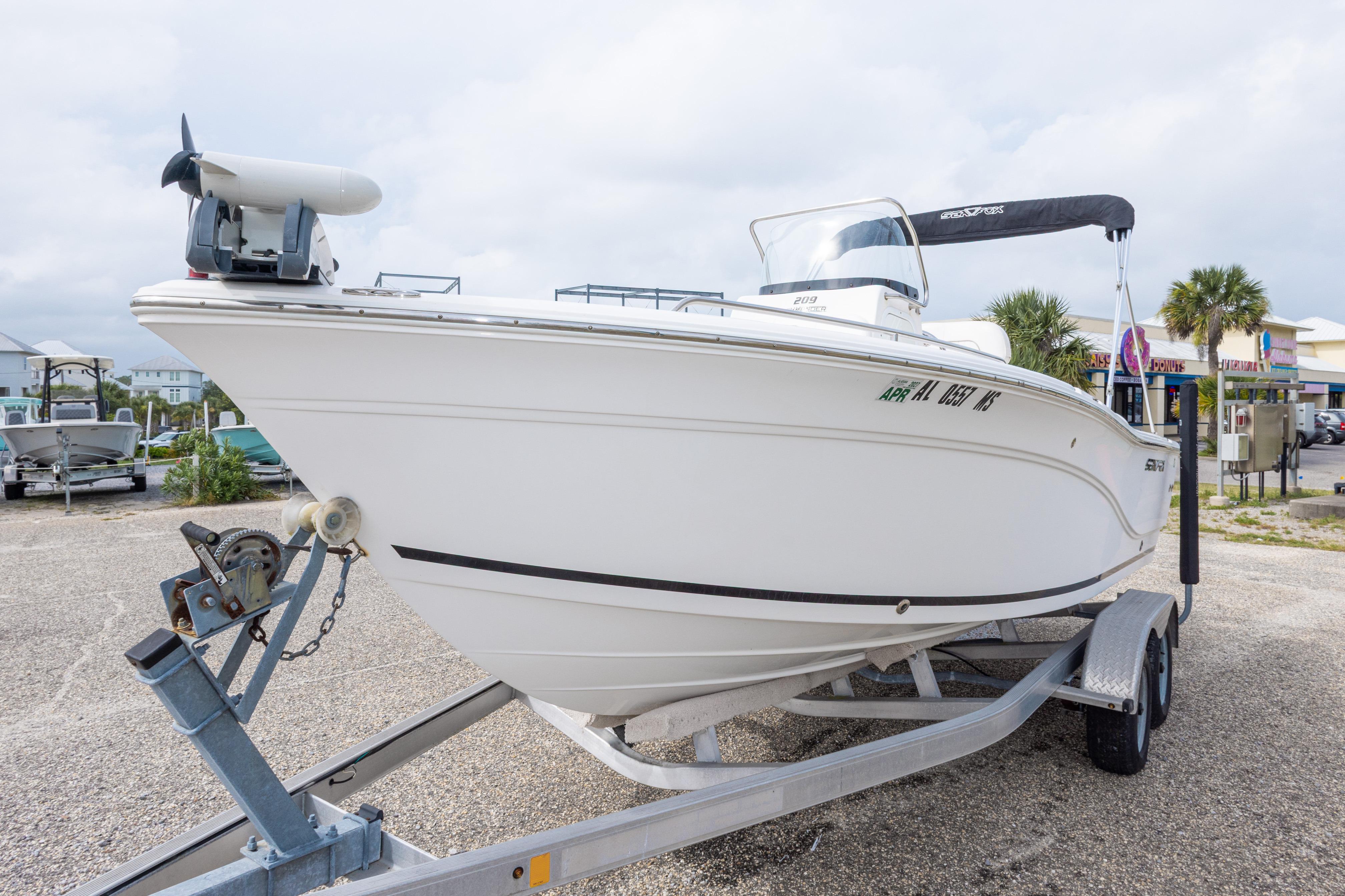 2014 Sea Fox 209 Commander boat on trailer, parked outdoors.