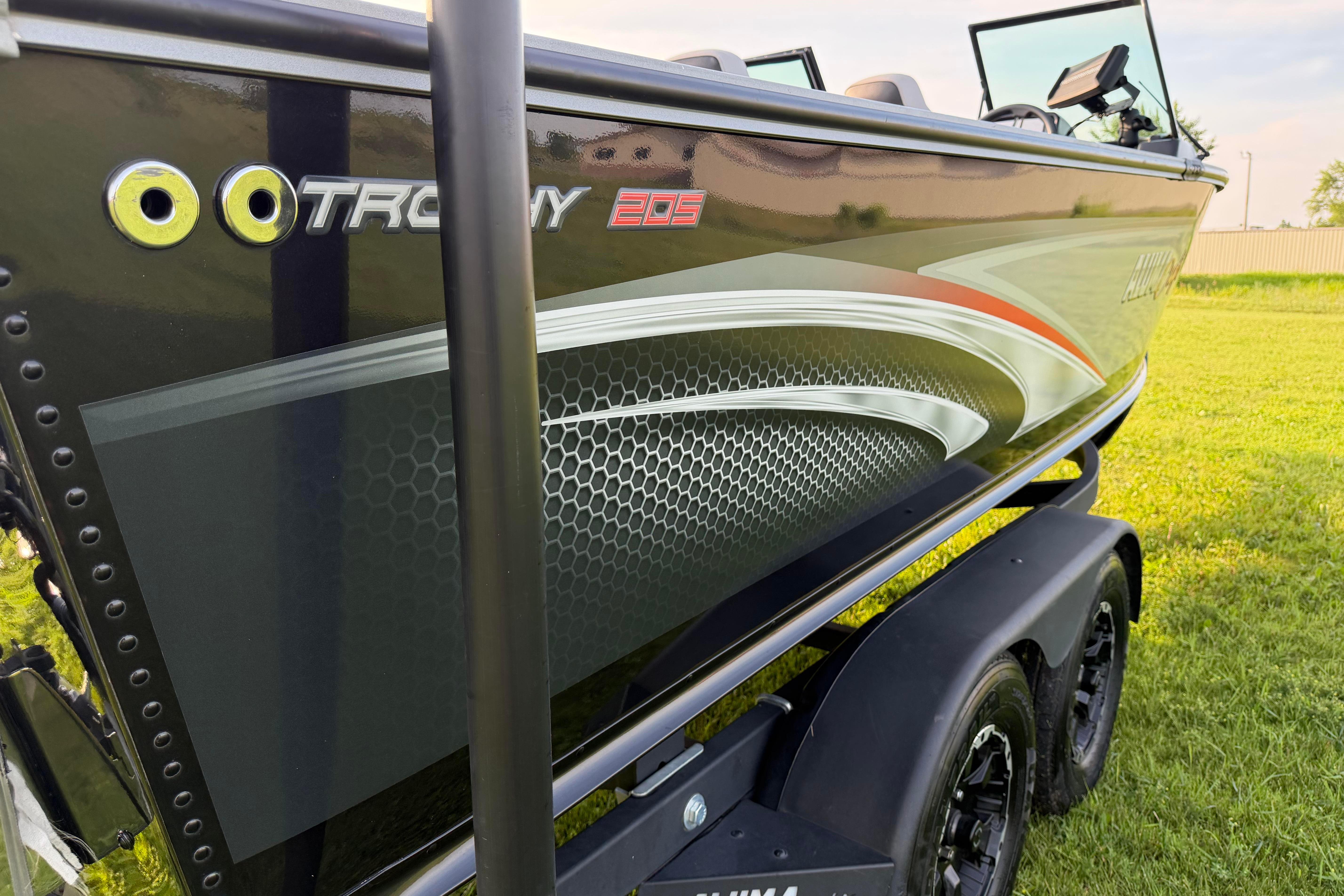 2019 Alumacraft Trophy 205 boat with sleek design on grassy field.
