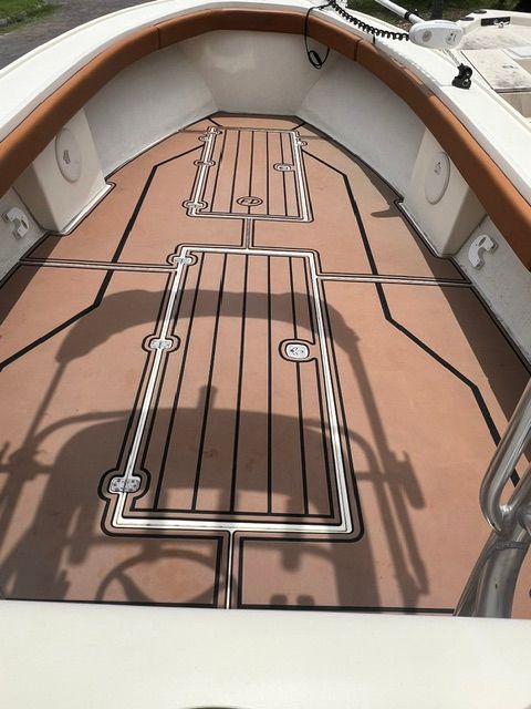 Interior view of a 2007 Dorado 30 boat deck with brown flooring.