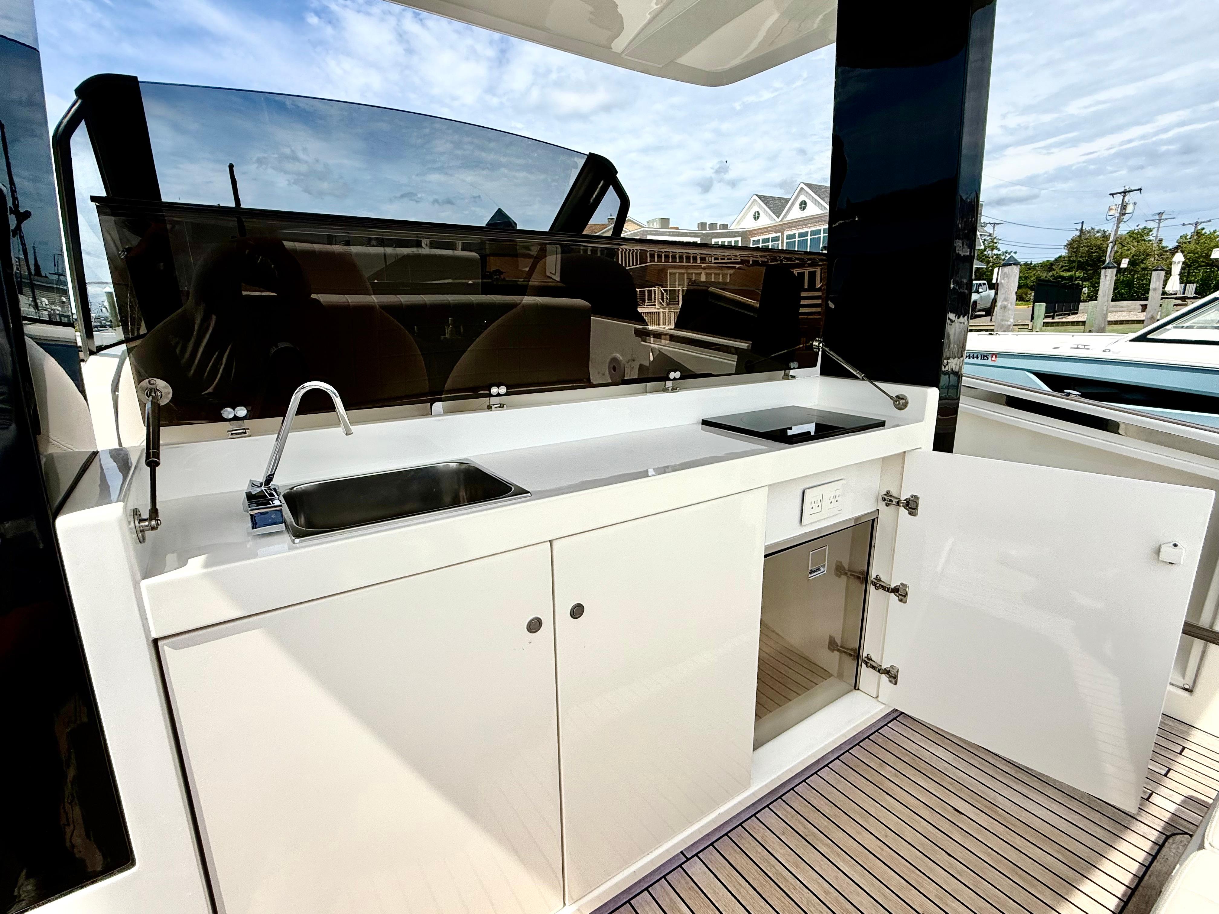2023 Astondoa 377 Coupe Outboard yacht kitchen with sink and storage.