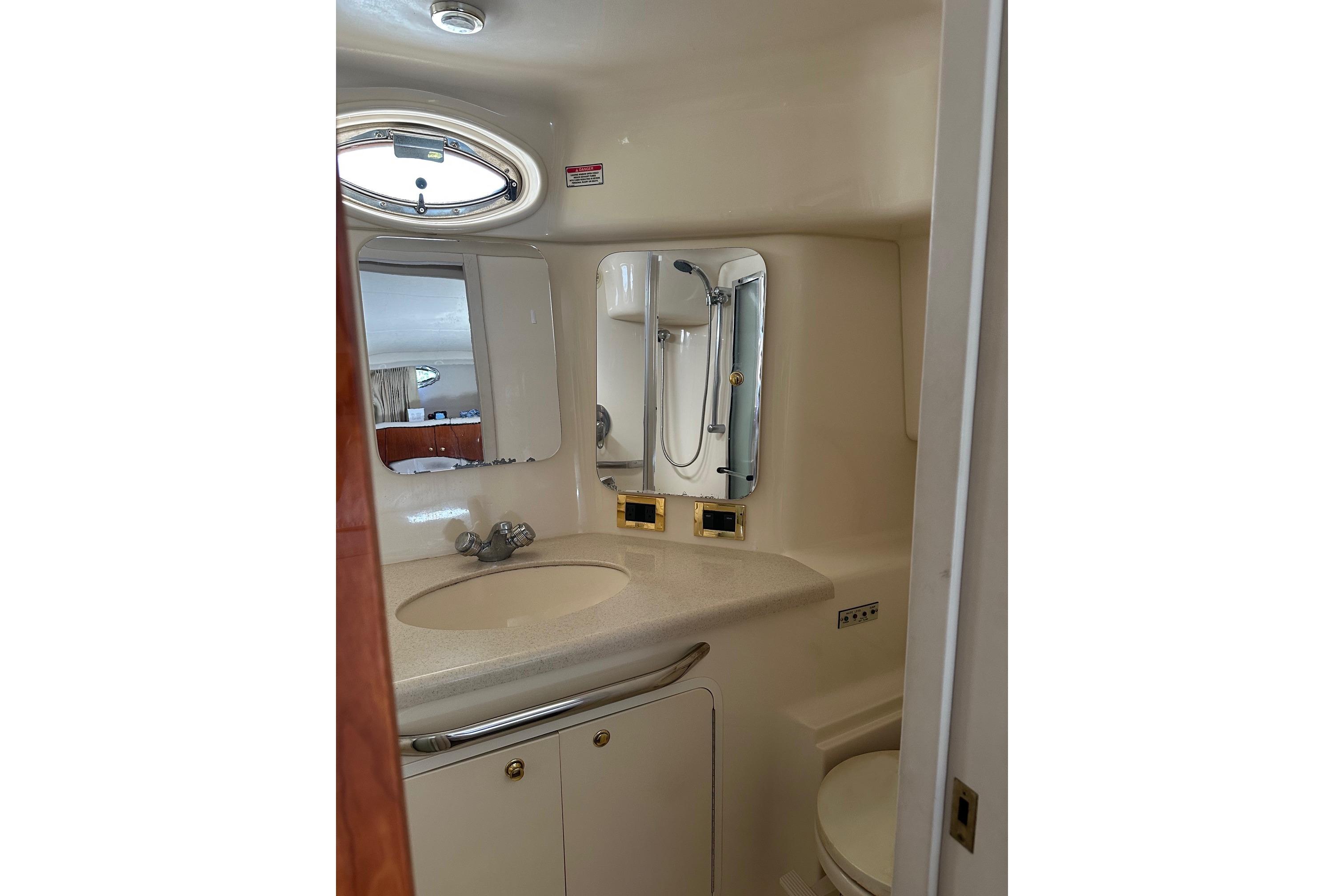 2000 Sea Ray 380 Aft Cabin bathroom with sink, mirror, and shower.