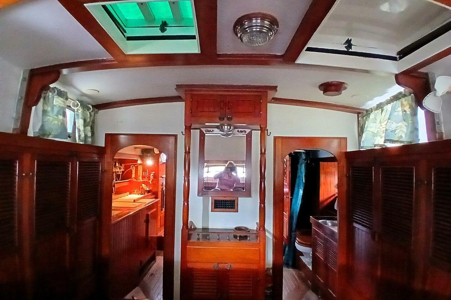 Interior of 1980 Hardin 45 sailboat with wooden cabinetry and nautical decor.