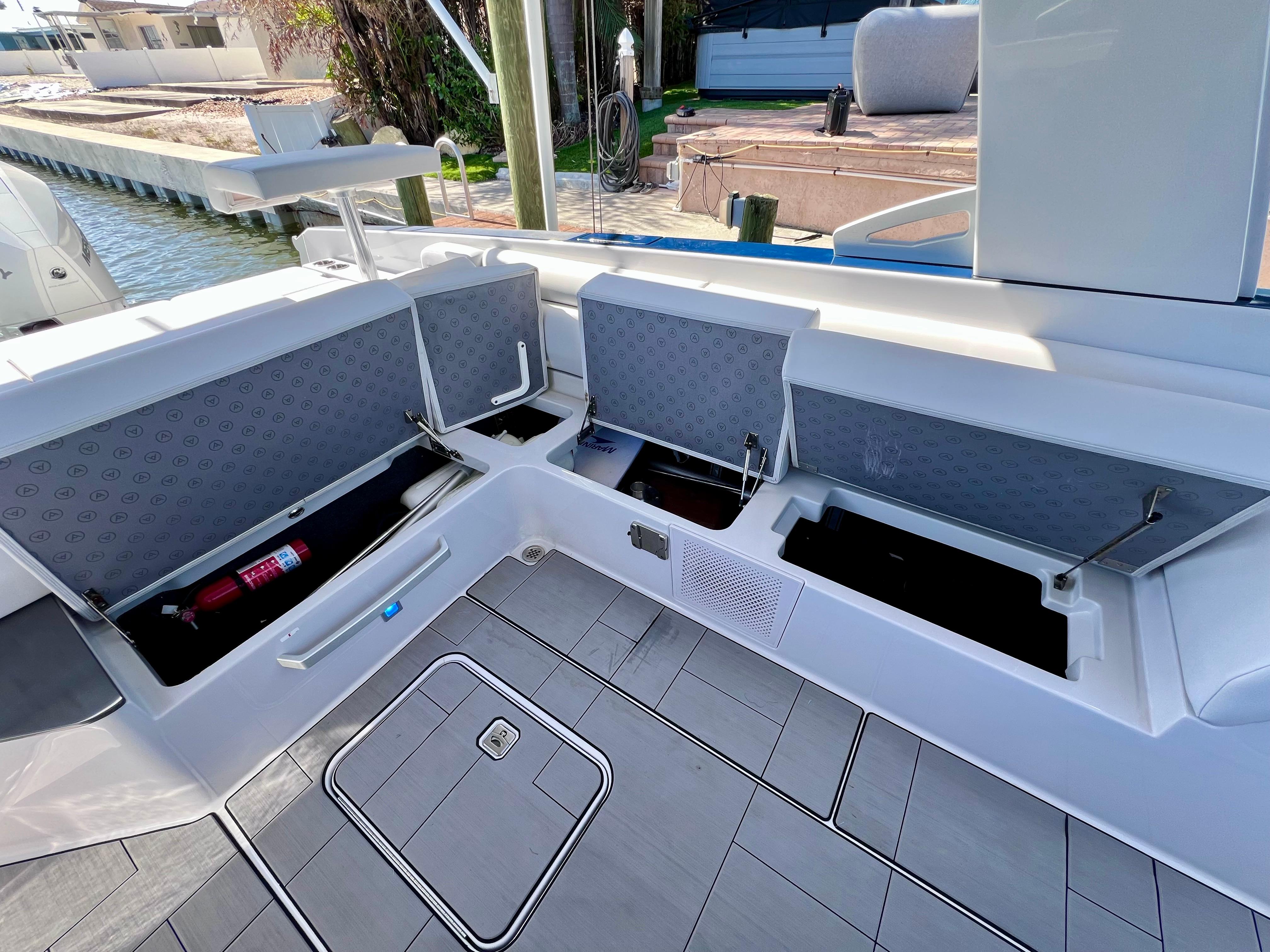 2022 Aviara AV 32 Outboard boat with open storage compartments and sleek deck design.
